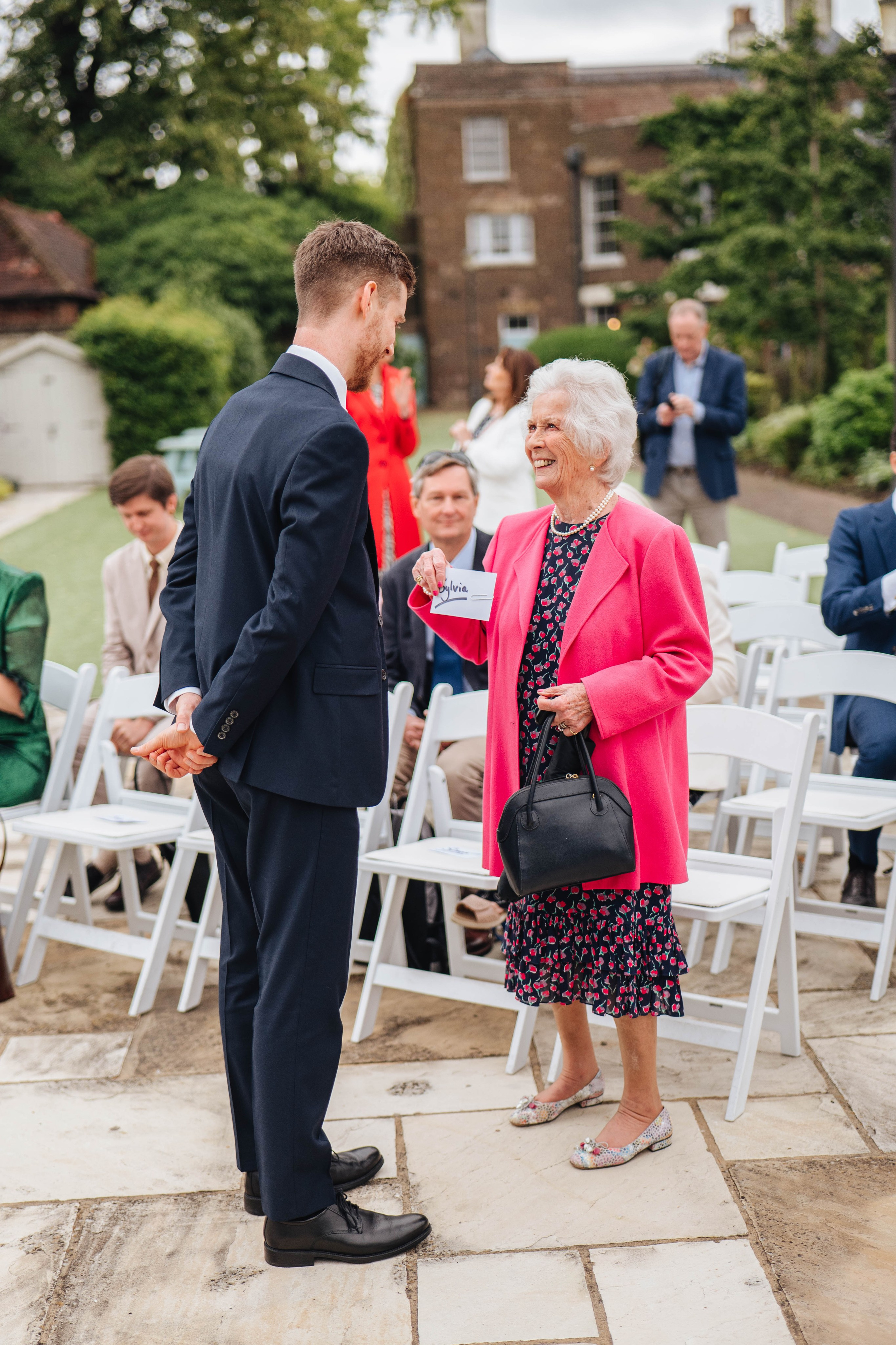 wedding guests chatting to each other before the ceremony