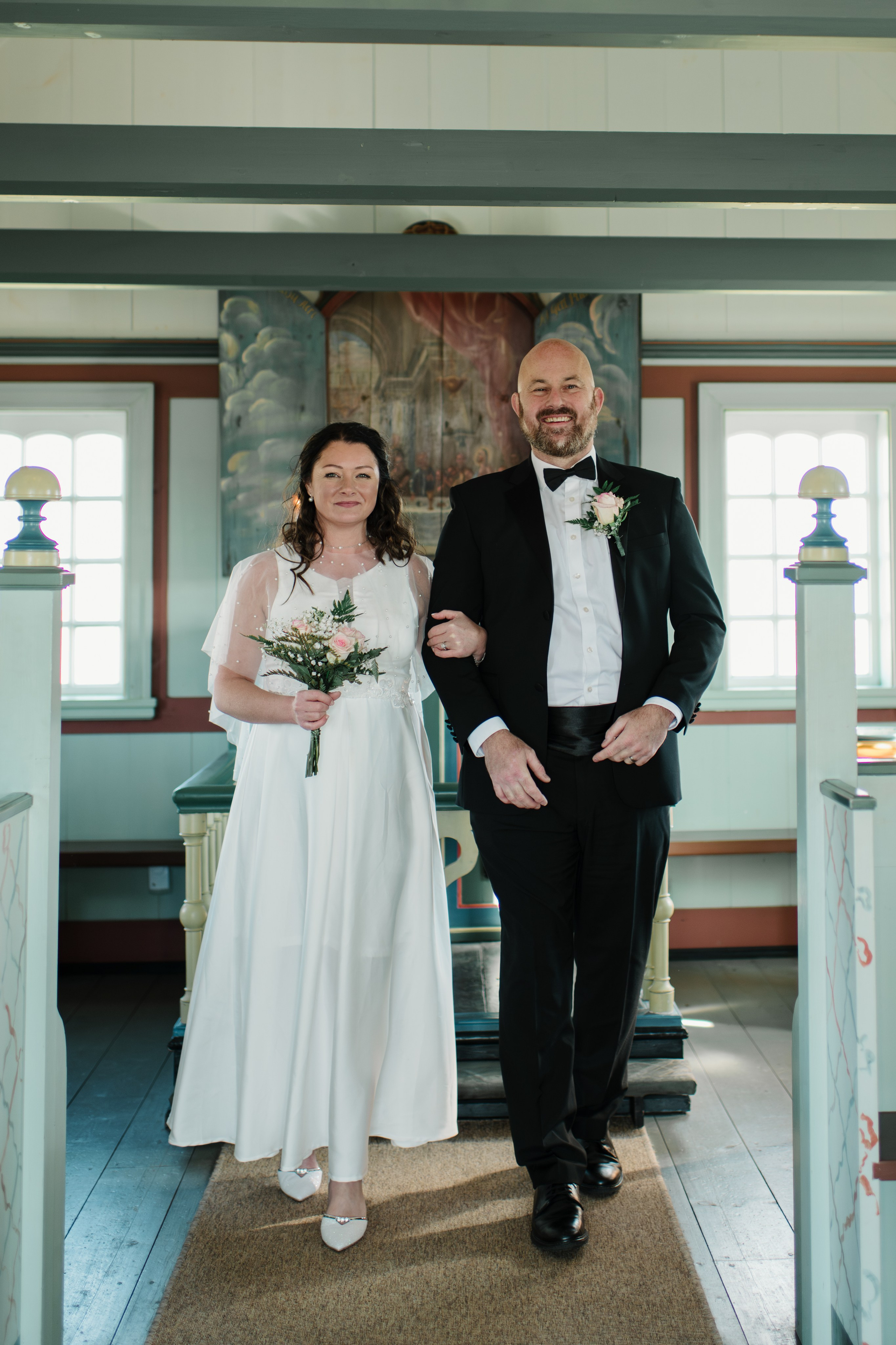 Candid moment of the wedding couple laughing near Búðir Church, surrounded by Iceland’s untamed nature.