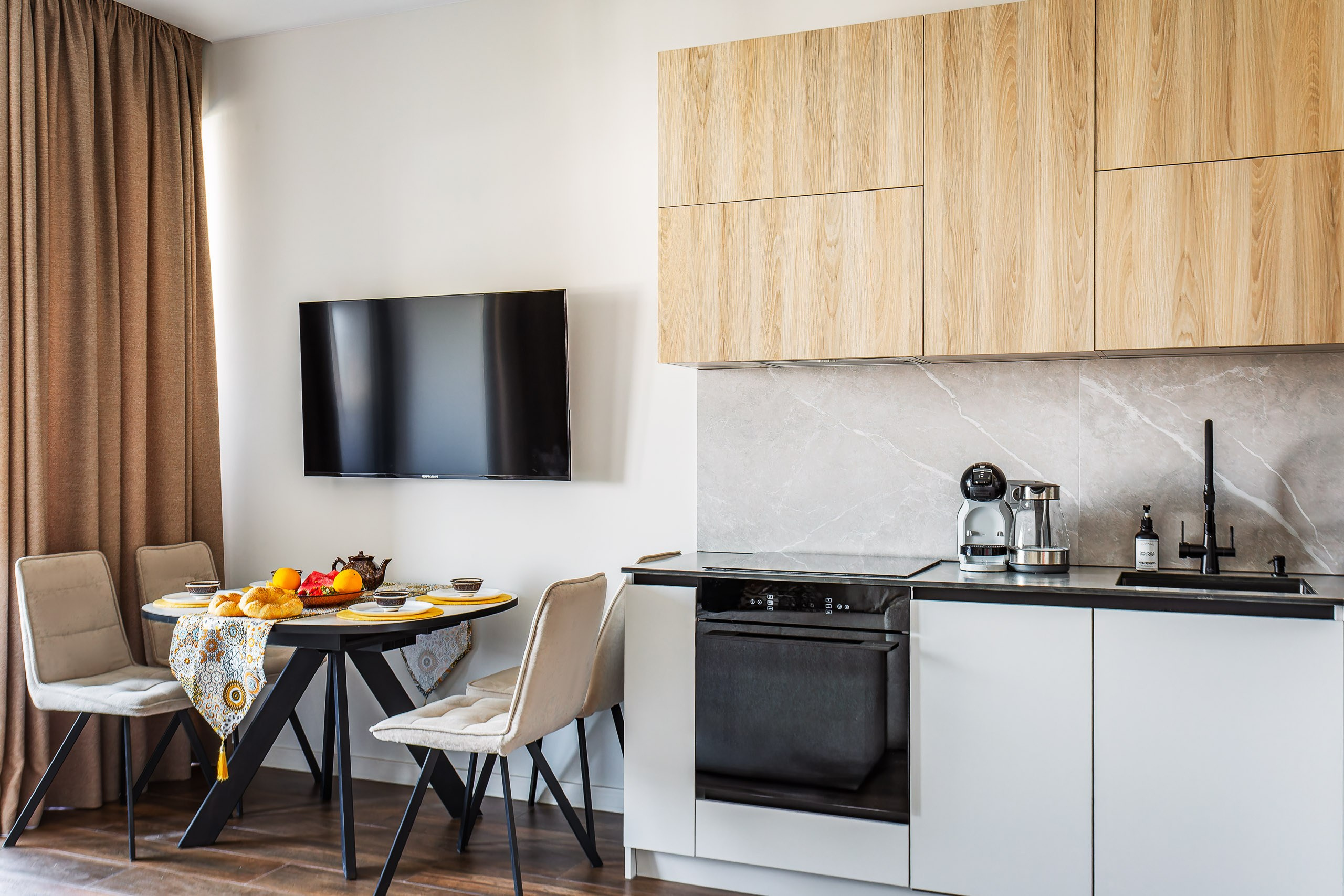 Interior photographer Uzbekistan — bright kitchen and dining area in minimalist style.