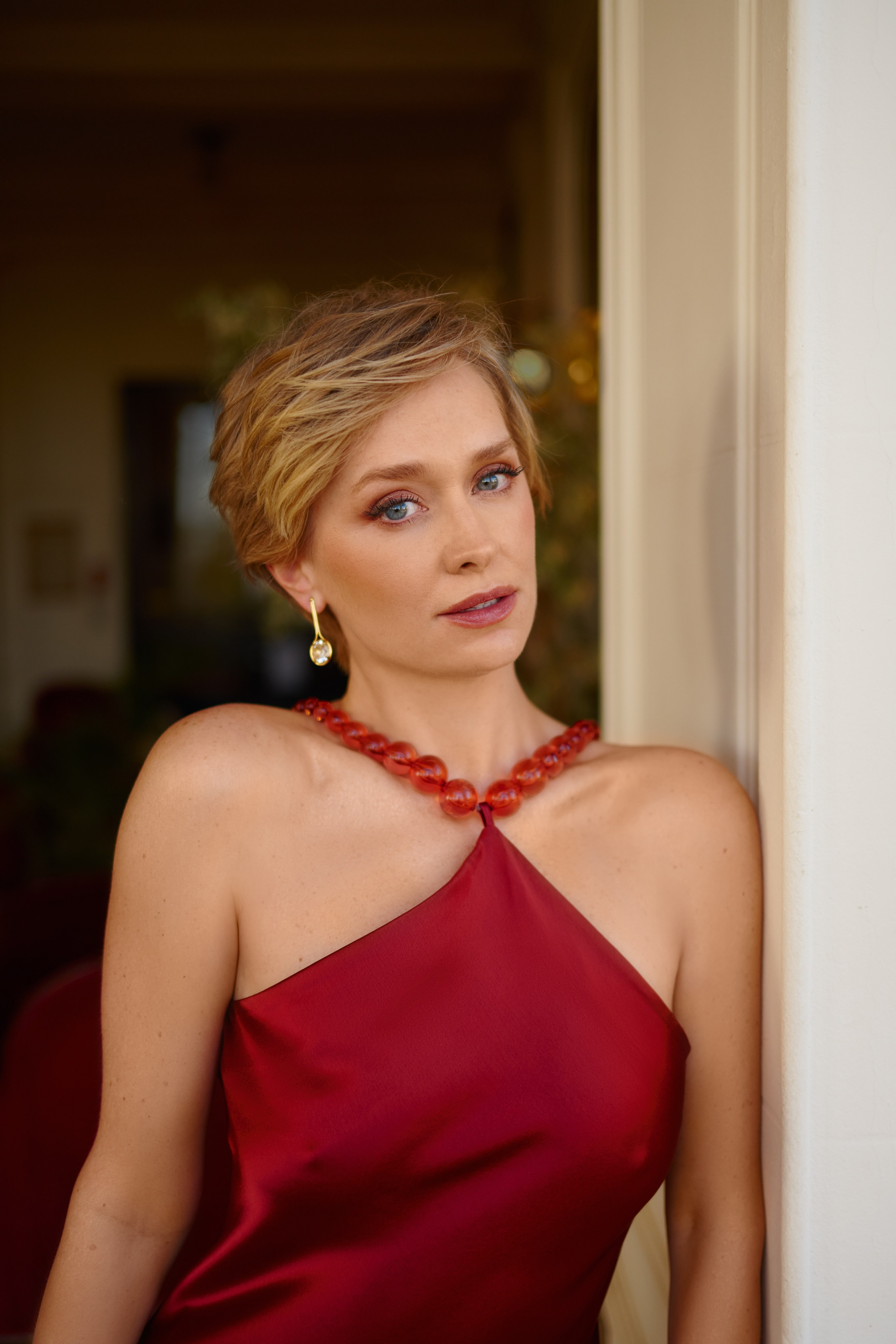 Close-up portrait of beautiful woman in elegant outfit in hotel interior Cannes