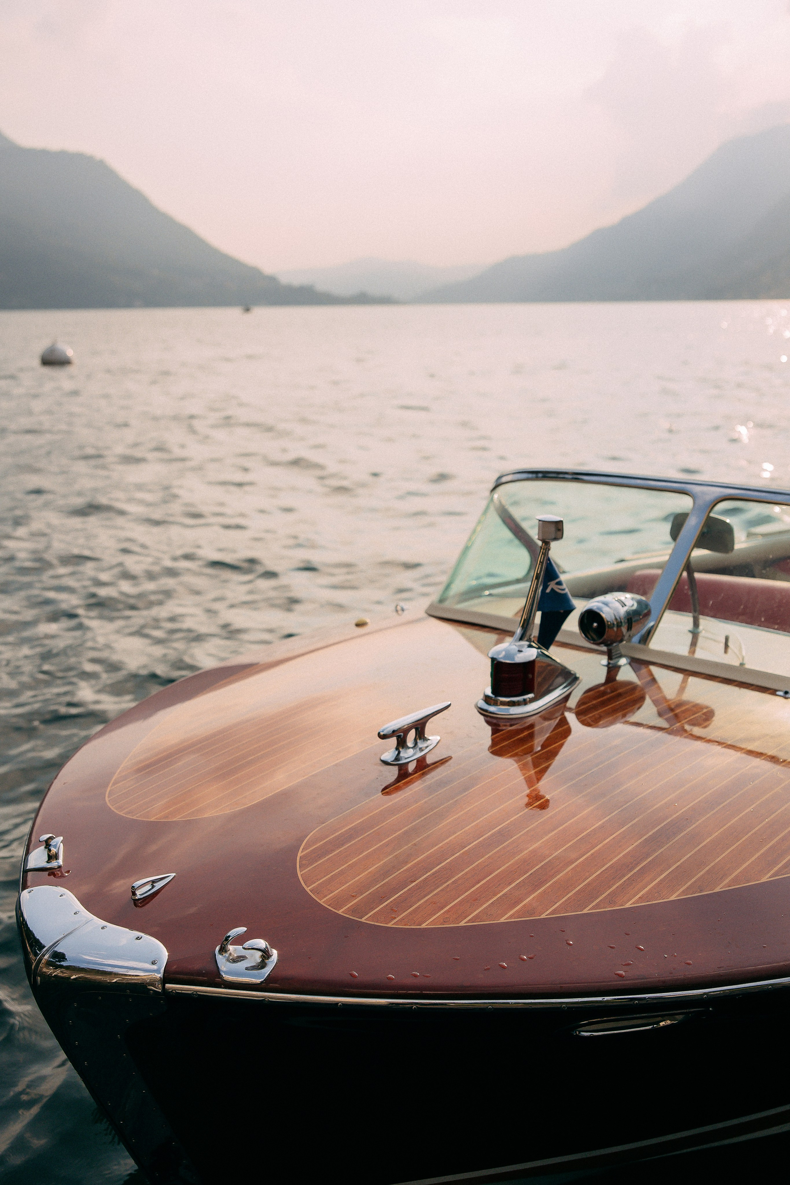 Wide shot of the couple on the boat at Villa Lario, Lake Como, Italy