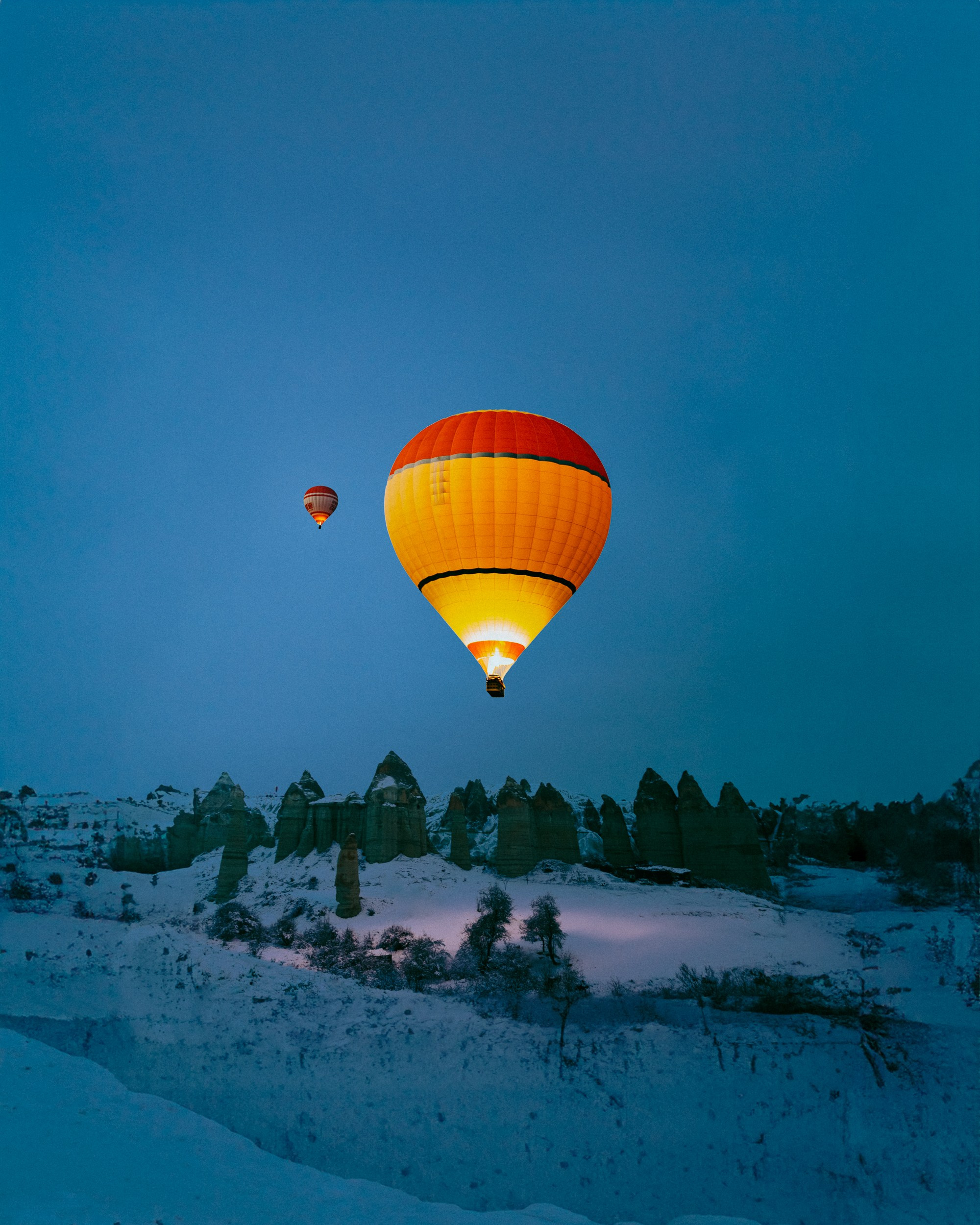A night photo of two hot air balloons in turkey during winter 