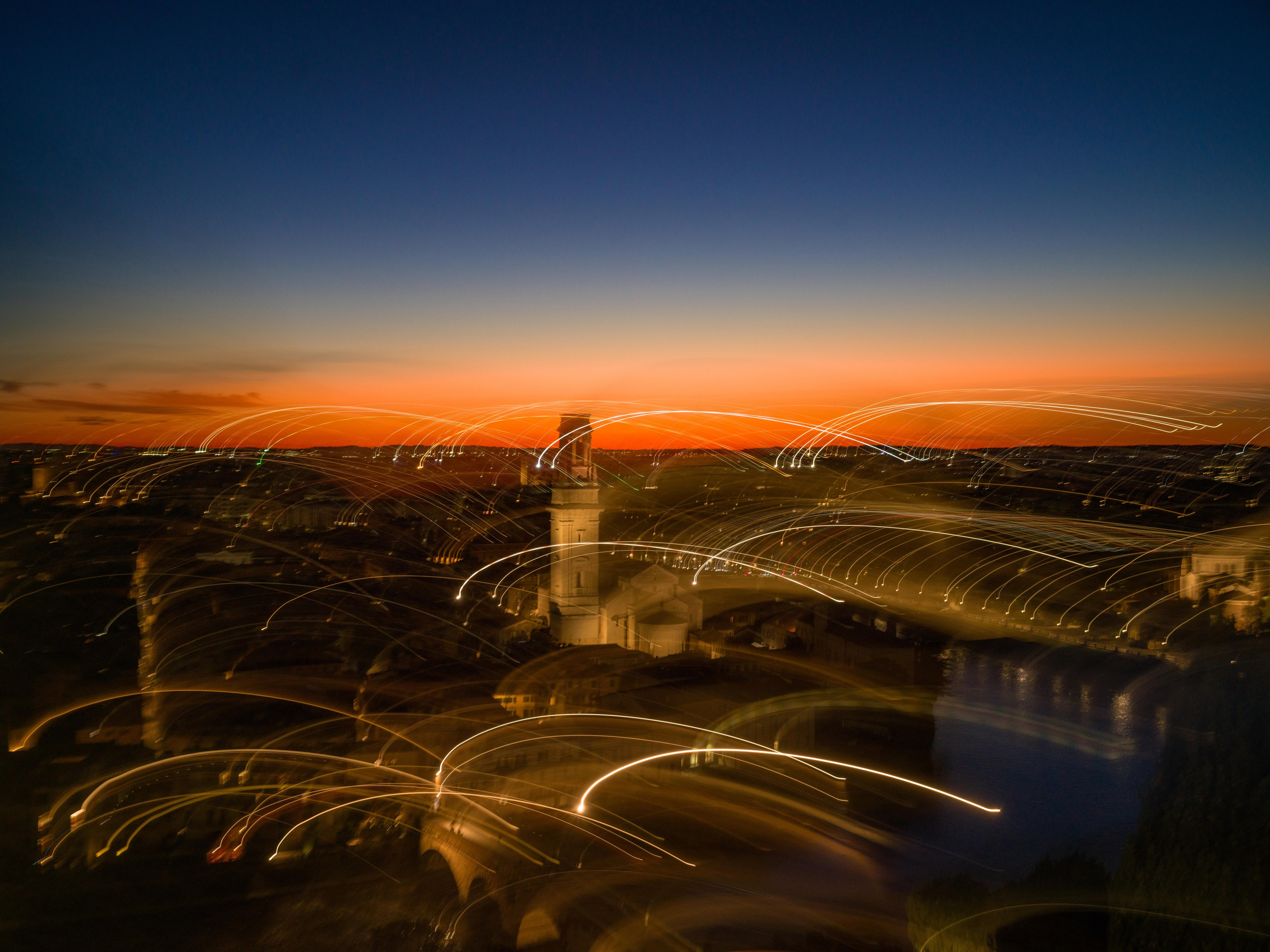 Long exposure sunset panorama of Verona with light trails across the historic city center