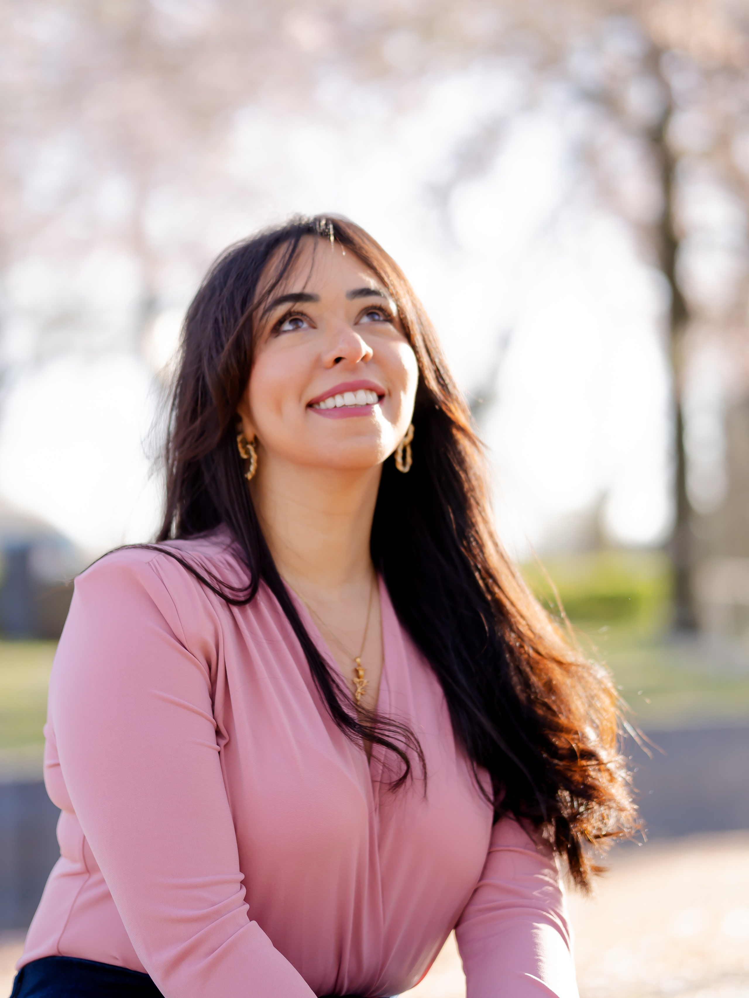 Woman staring at cherry blossom flowers