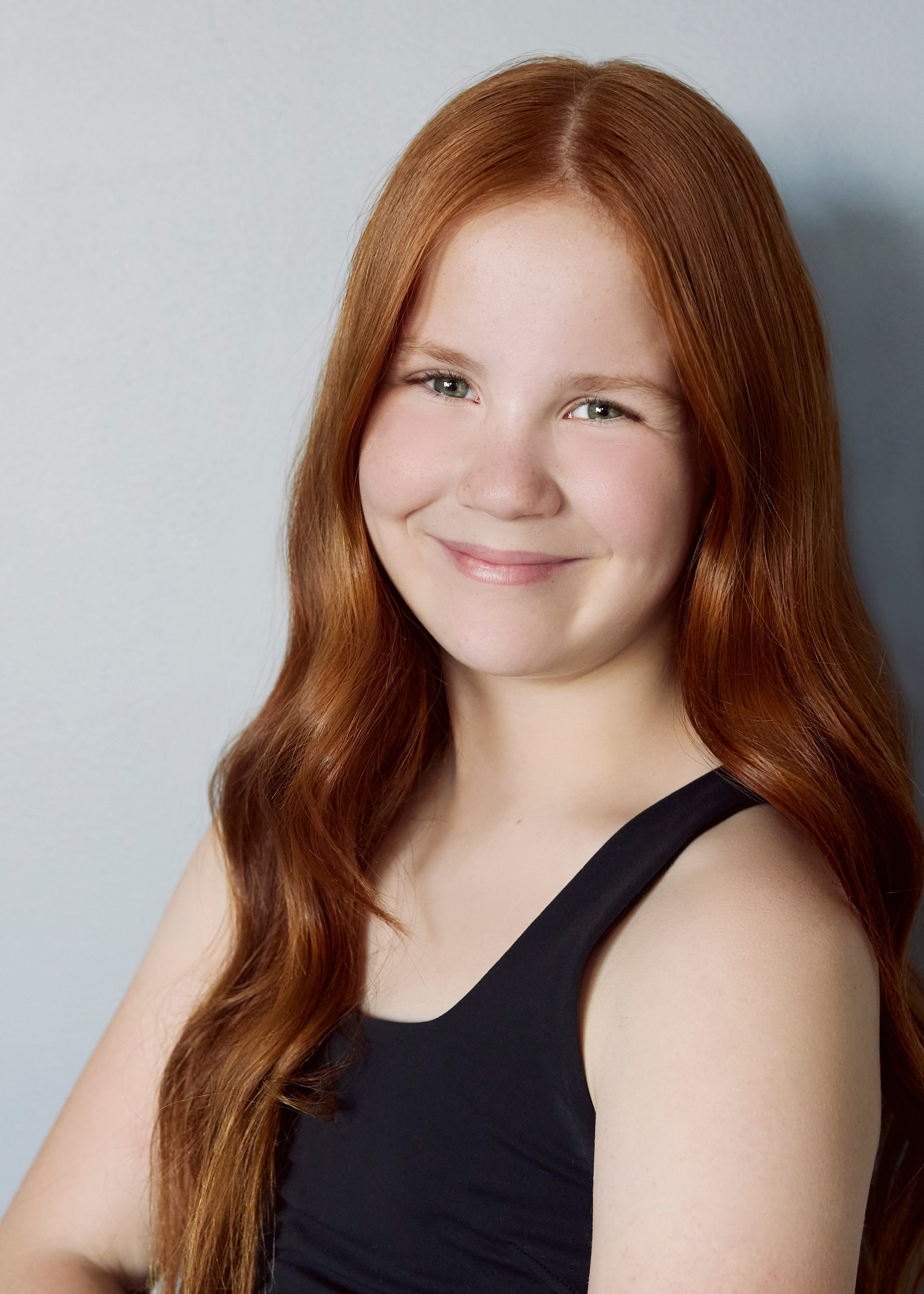 headshot of young red haired dancer with green eyes