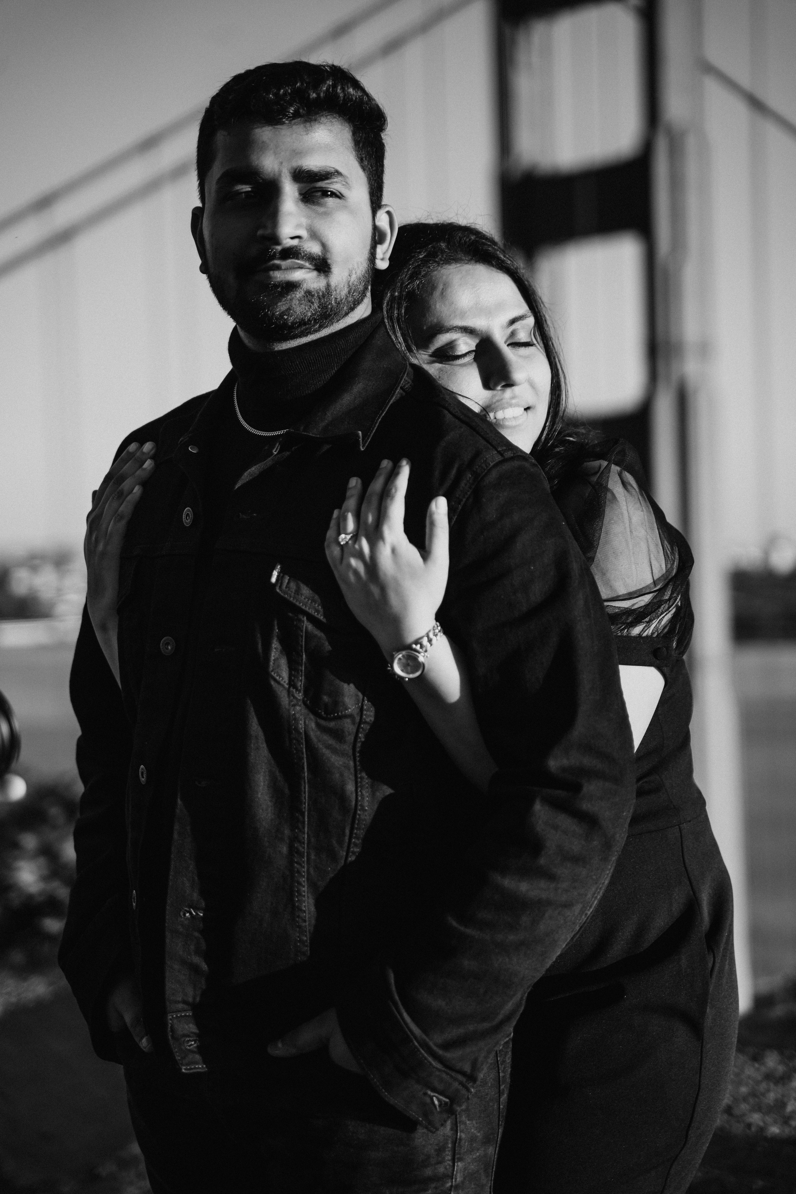 Proposal.  Overlooking the golden San Franisco Bridge sunset with a couple. Photographer Video. 