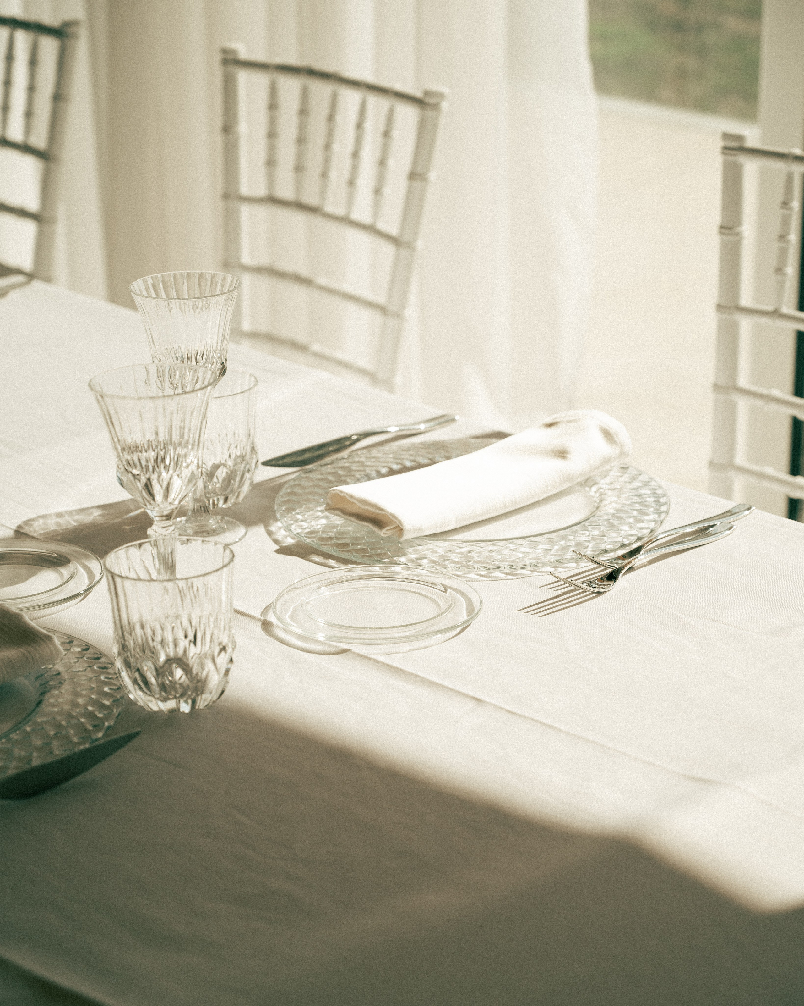 Elegant wedding reception table setting with fine dinnerware and floral details