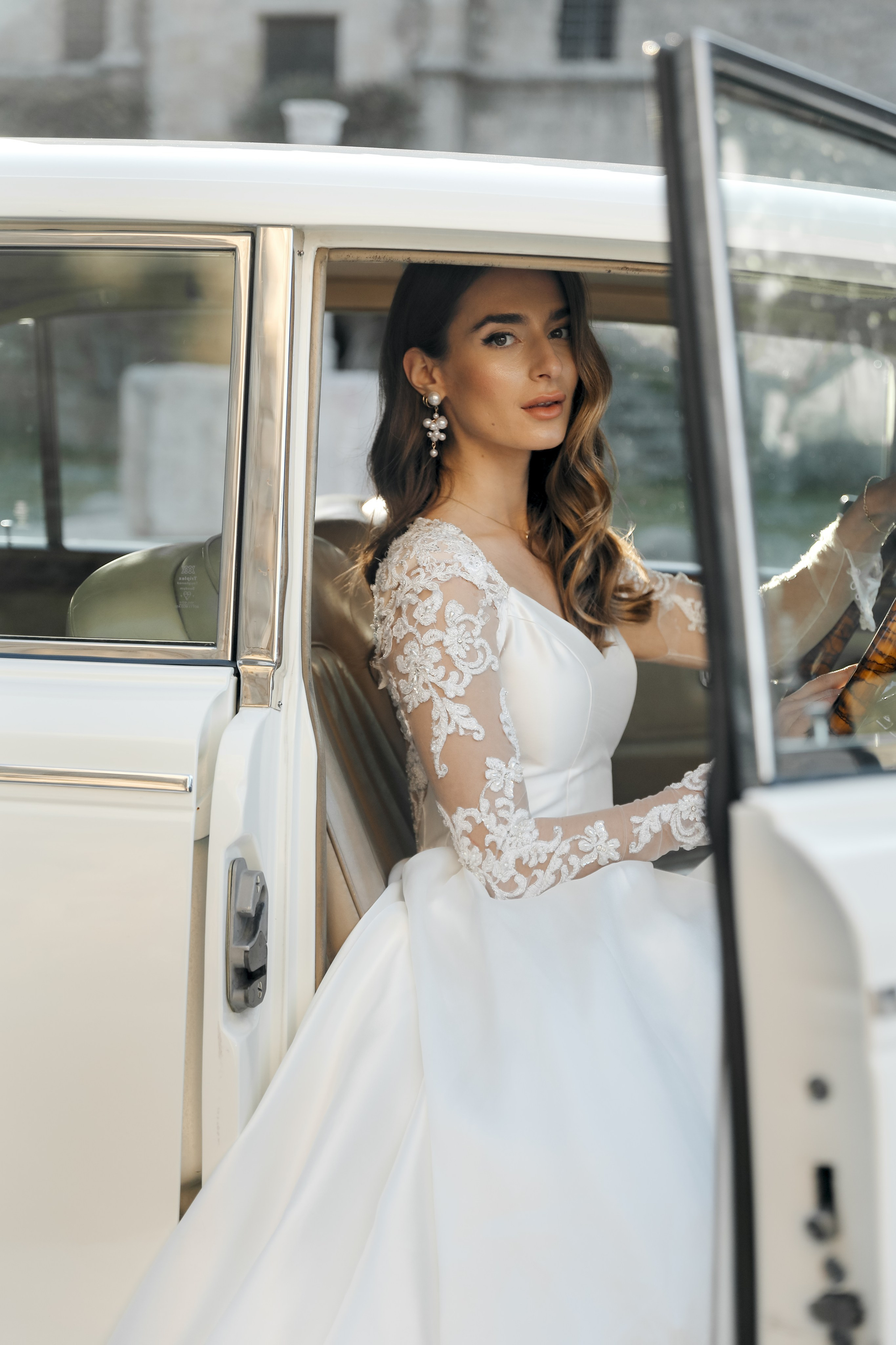 A portrait of a beautiful bride  in Rolls Royce in old town of Rhodes island, Greece