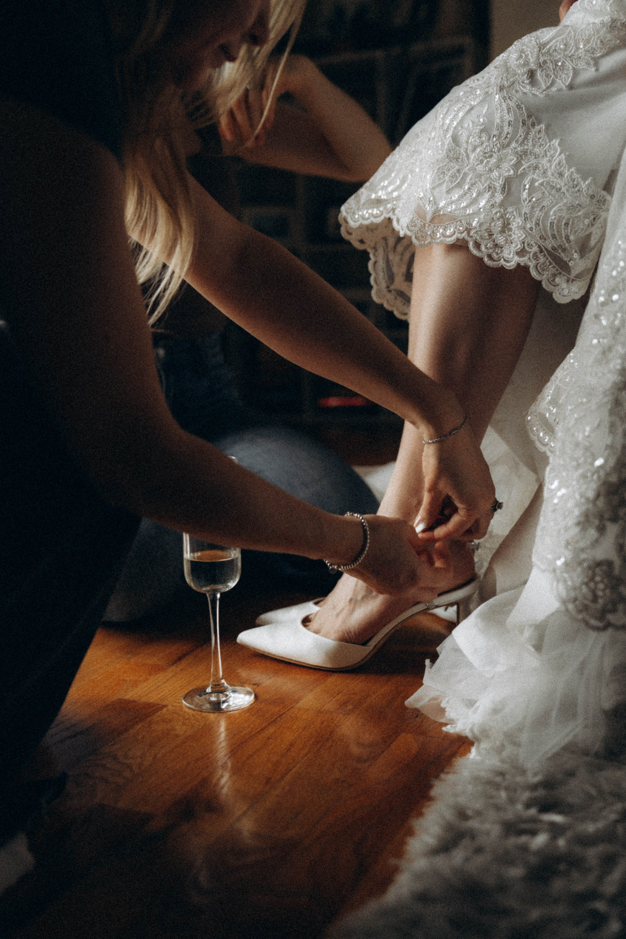 Bride walking along Amsterdam bridge at dusk.