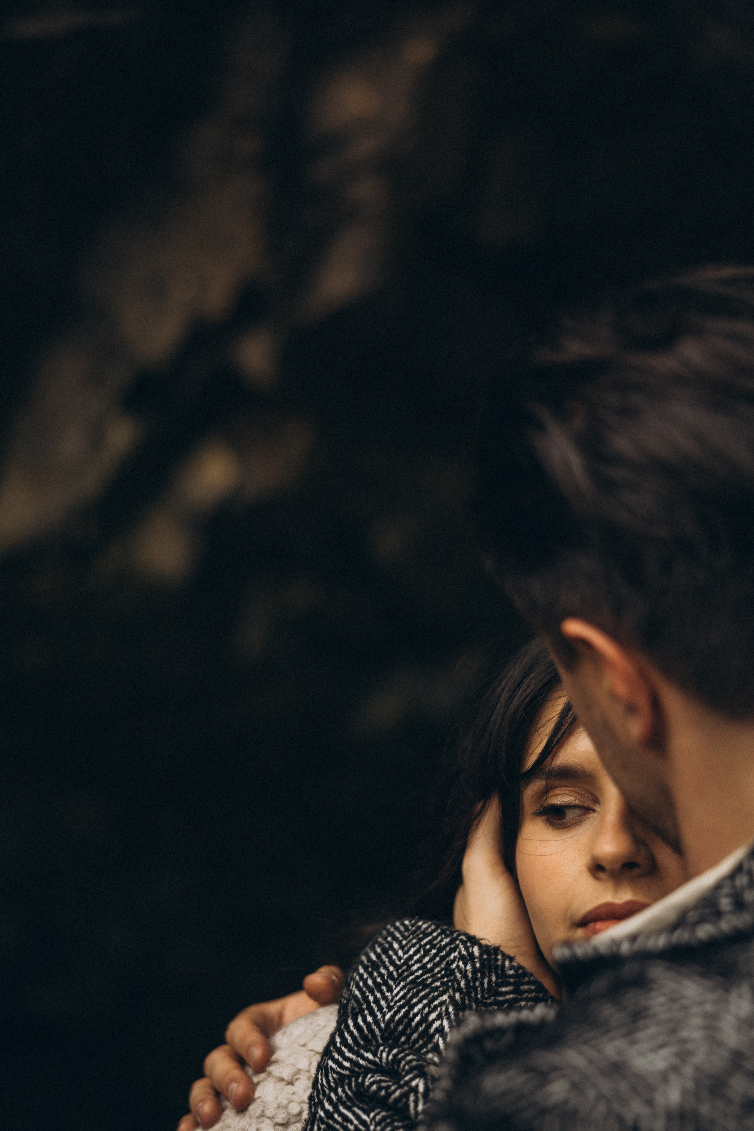 Couple holding hands and walking through a picturesque coastline in Portugal.