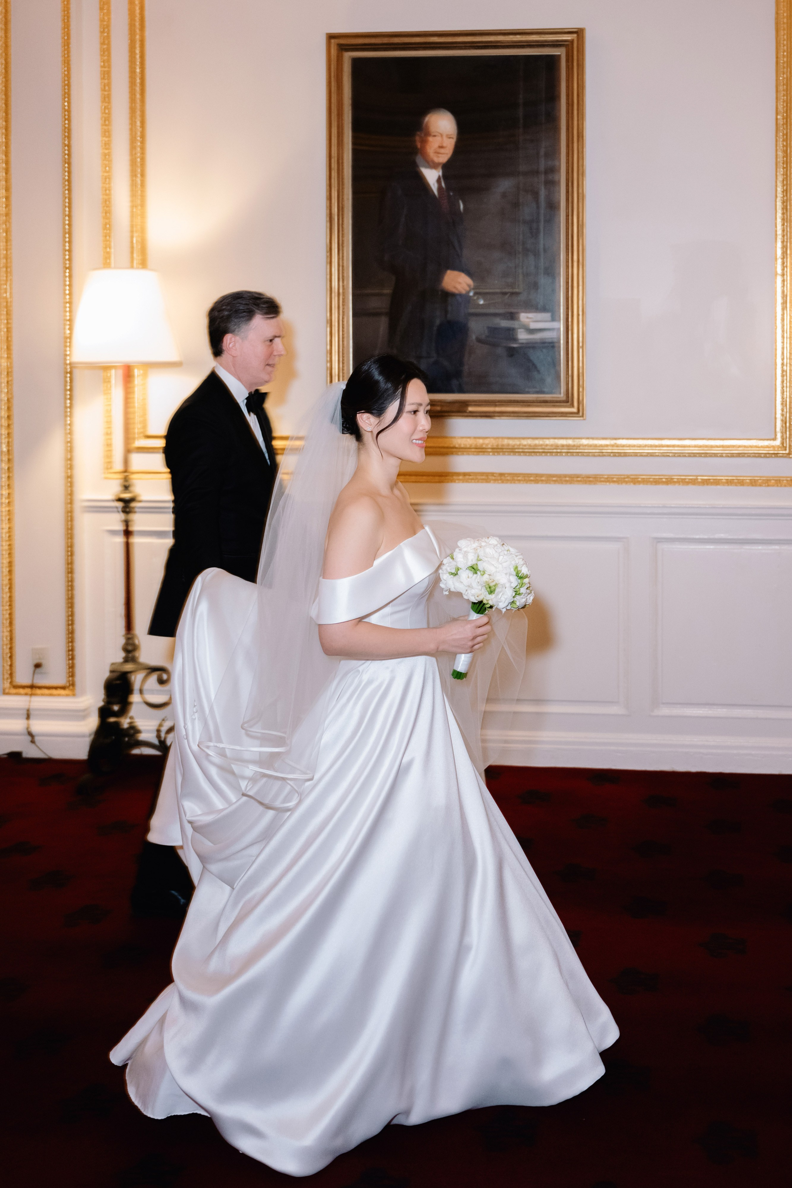 a bride and groom walking in a room
