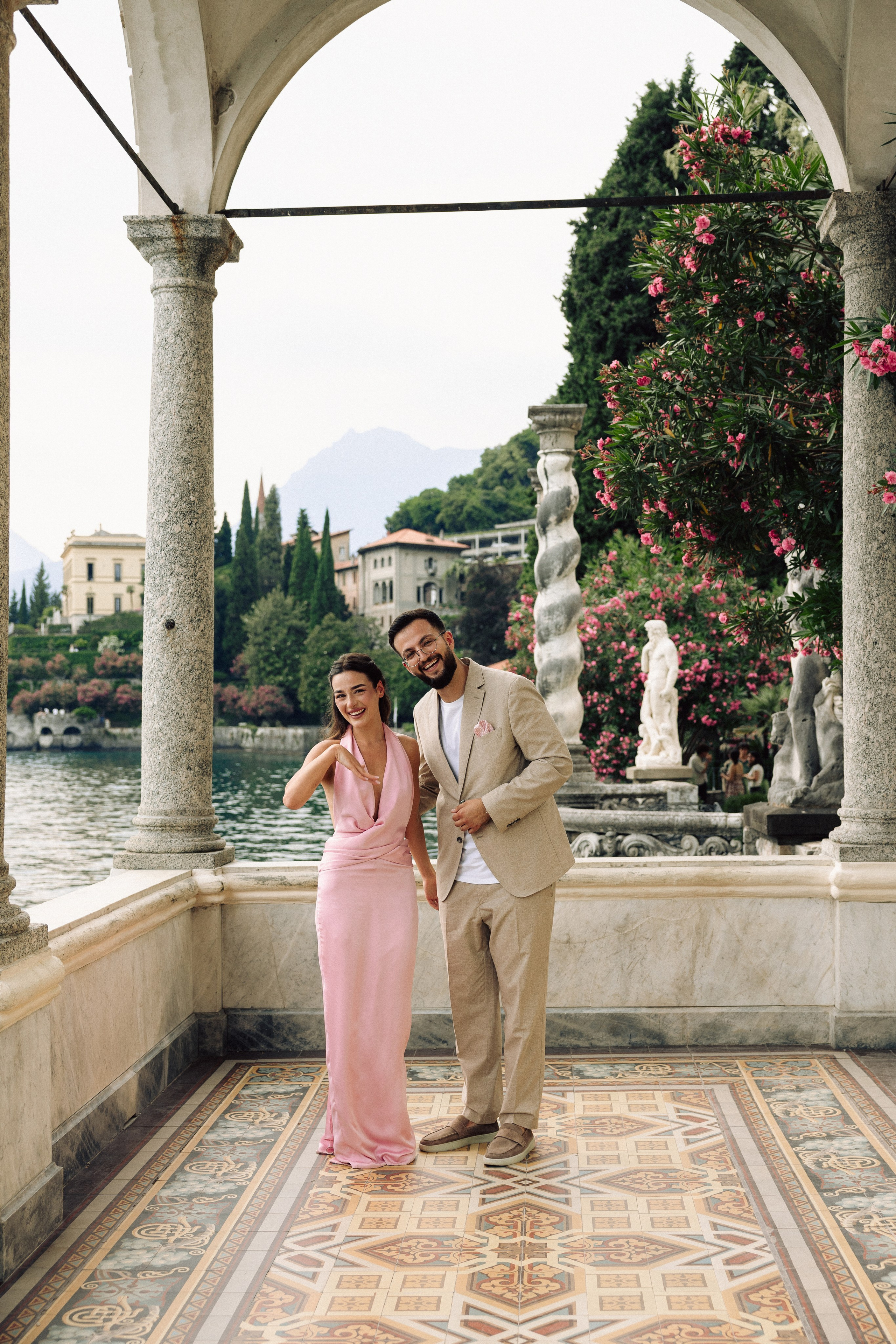 Couple celebrating their engagement after a romantic proposal on Lake Como at  Villa Monastero in Varenna 
