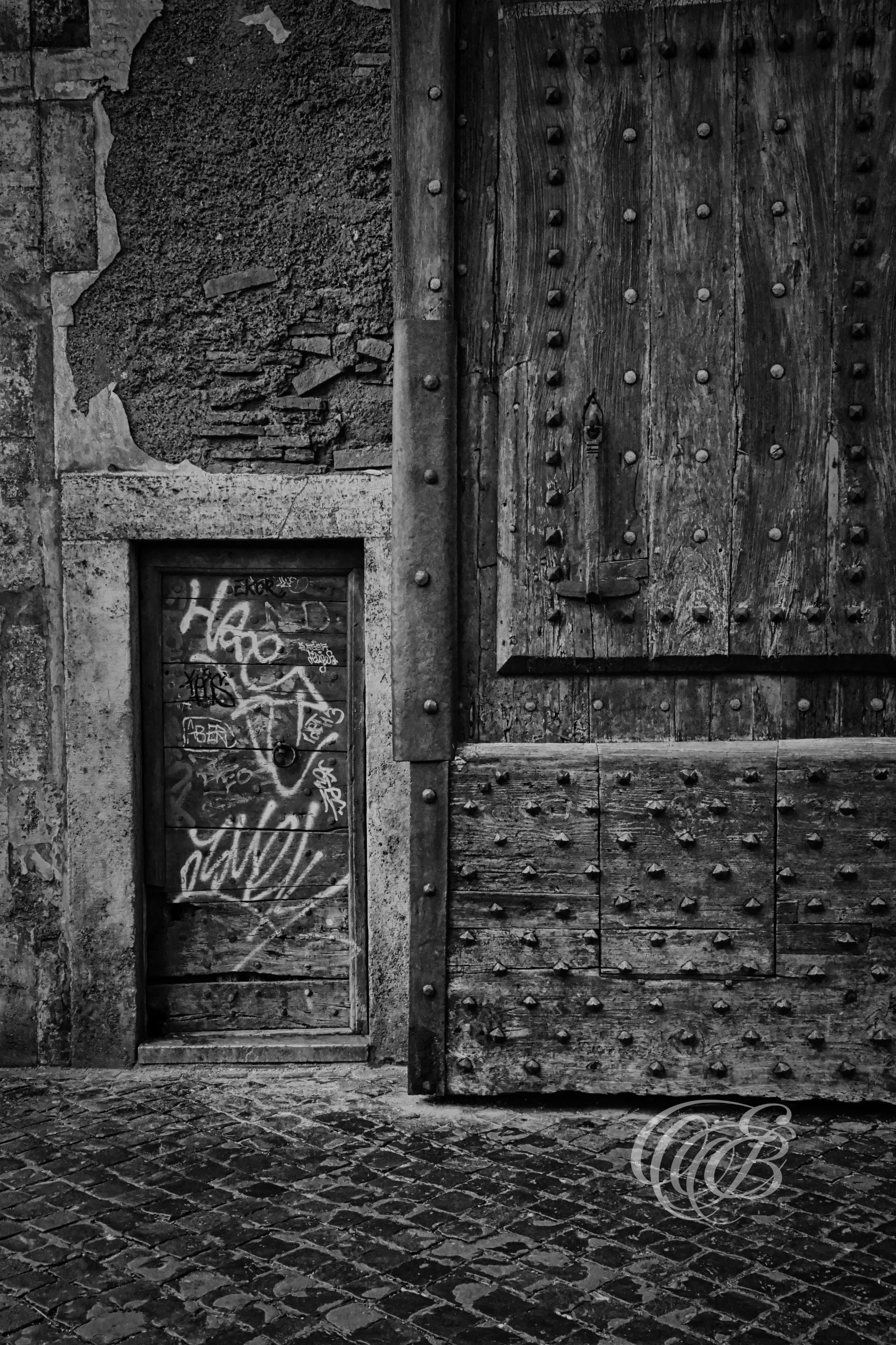 Rome Italy - The Porta del Popolo - B&W - Eduardo Bartoli Fine Art Photography - Black and white fine art photograph showing a partial view of the open door and side door at Porta del Popolo in Rome, Italy – photography by Eduardo Bartoli.