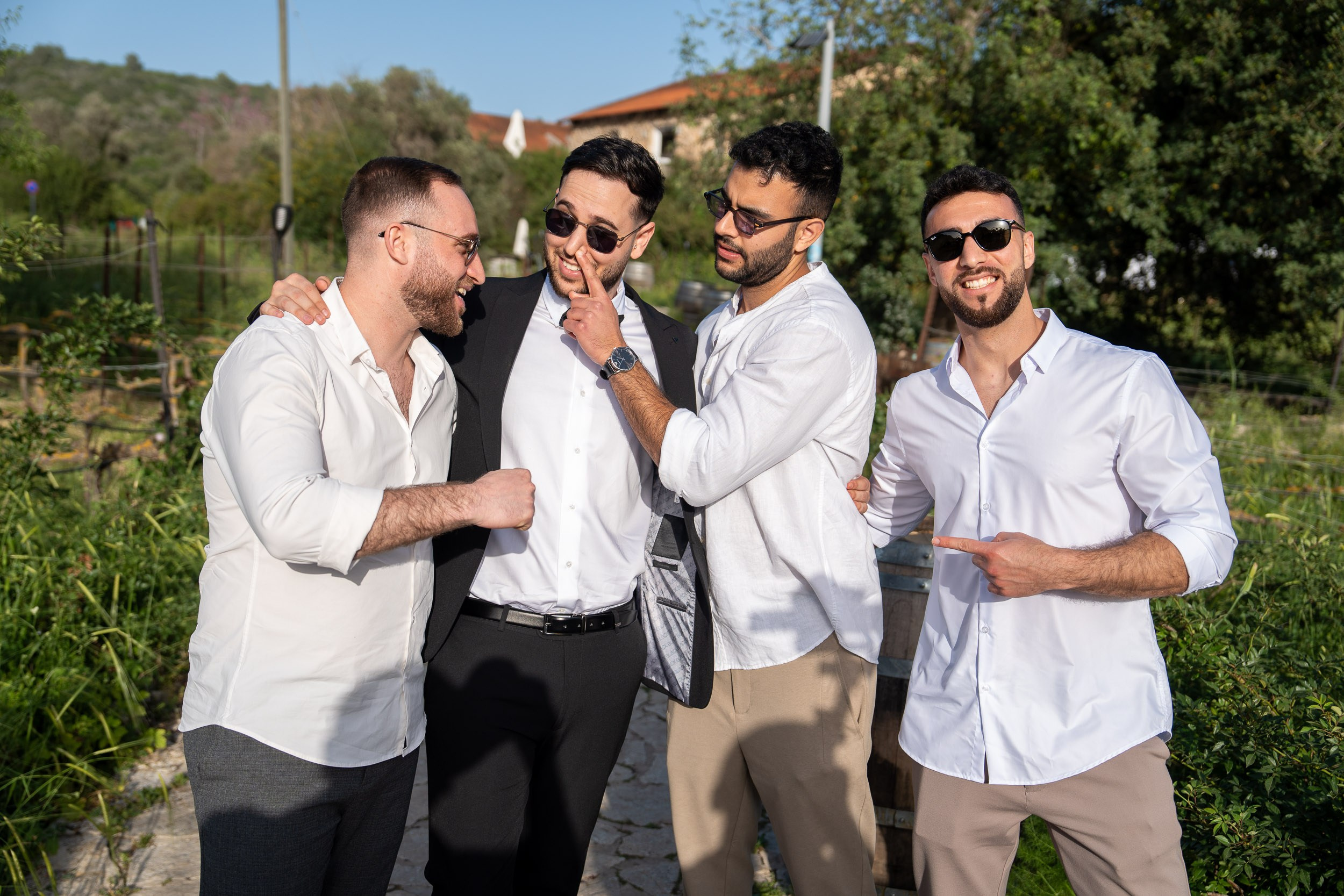 Groom and his friends in sunglasses sharing a laugh during a wedding celebration in Israel