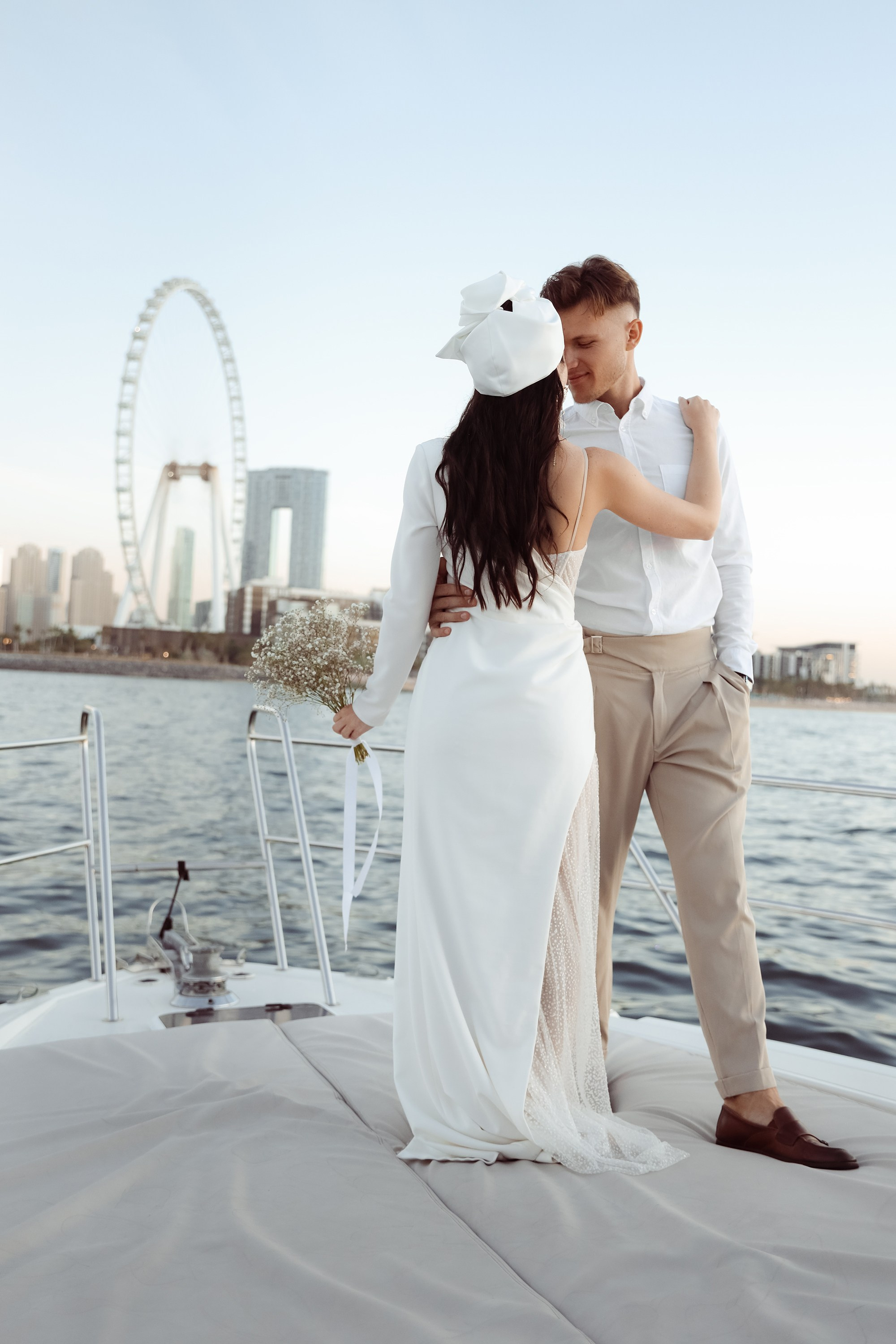 A couple’s love story told through portraits on a yacht: together, they share an embrace. Dubai, United Arab Emirates