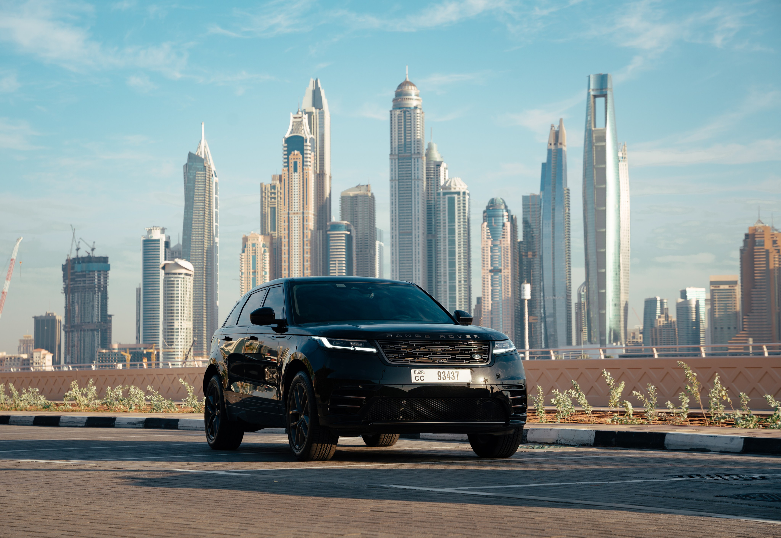 Black Range Rover in Front of Dubai Marina: In this image, a black Range Rover is showcased head-on, set against the impressive Dubai Marina skyline. The photoshoot, conducted on Palm Jumeirah, emphasizes the vehicle’s robust presence, complemented by the modern architectural marvels in the background