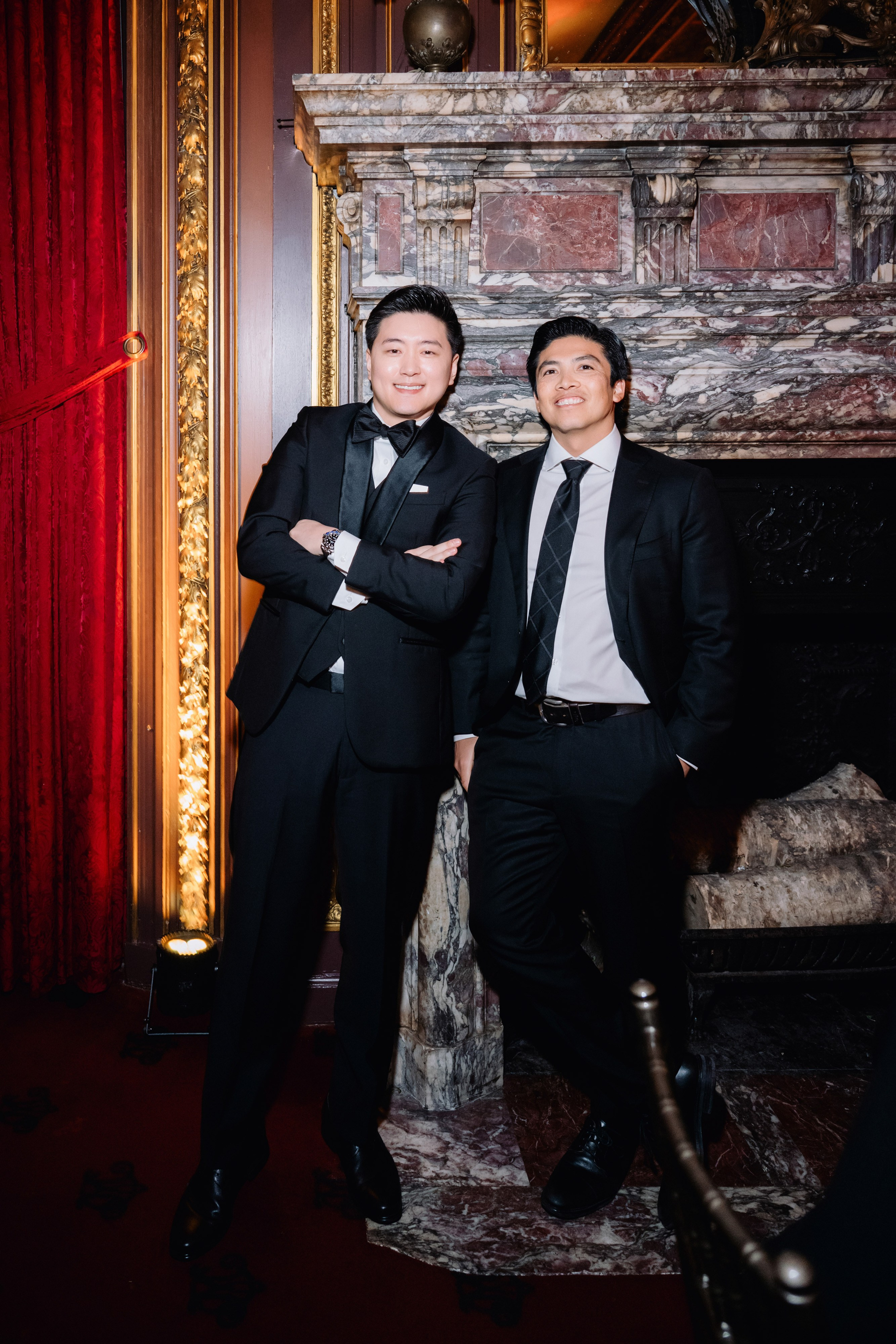 two men in suits posing for a picture