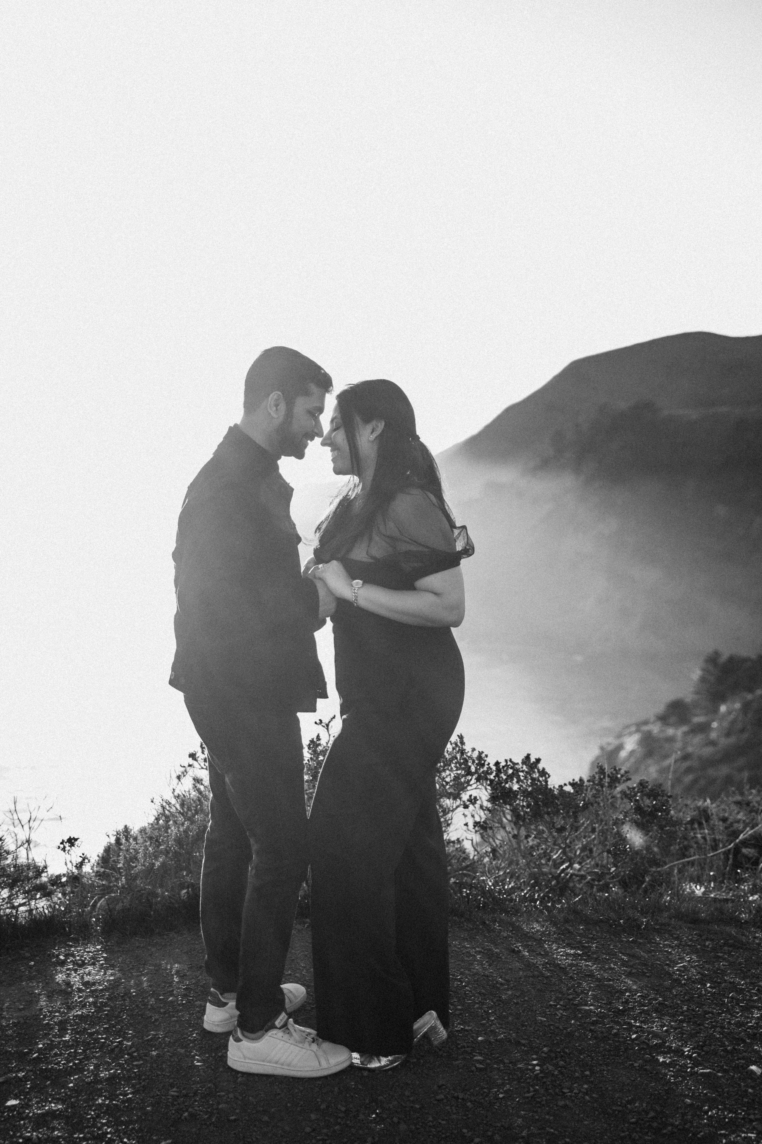 Proposal.  Overlooking the golden San Franisco Bridge sunset with a couple. Photographer Video. 