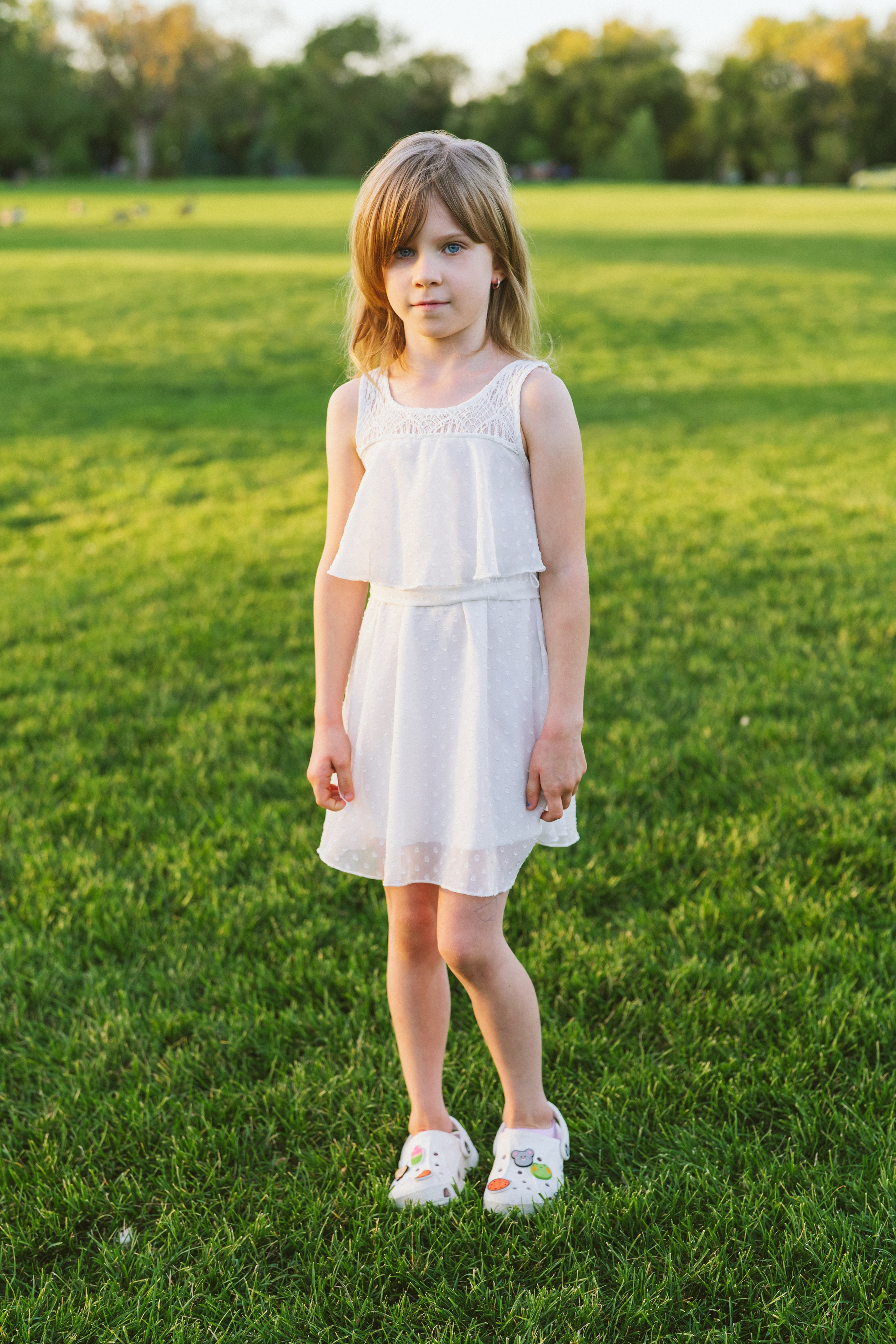 Little girl with blue eyes in a white dress 