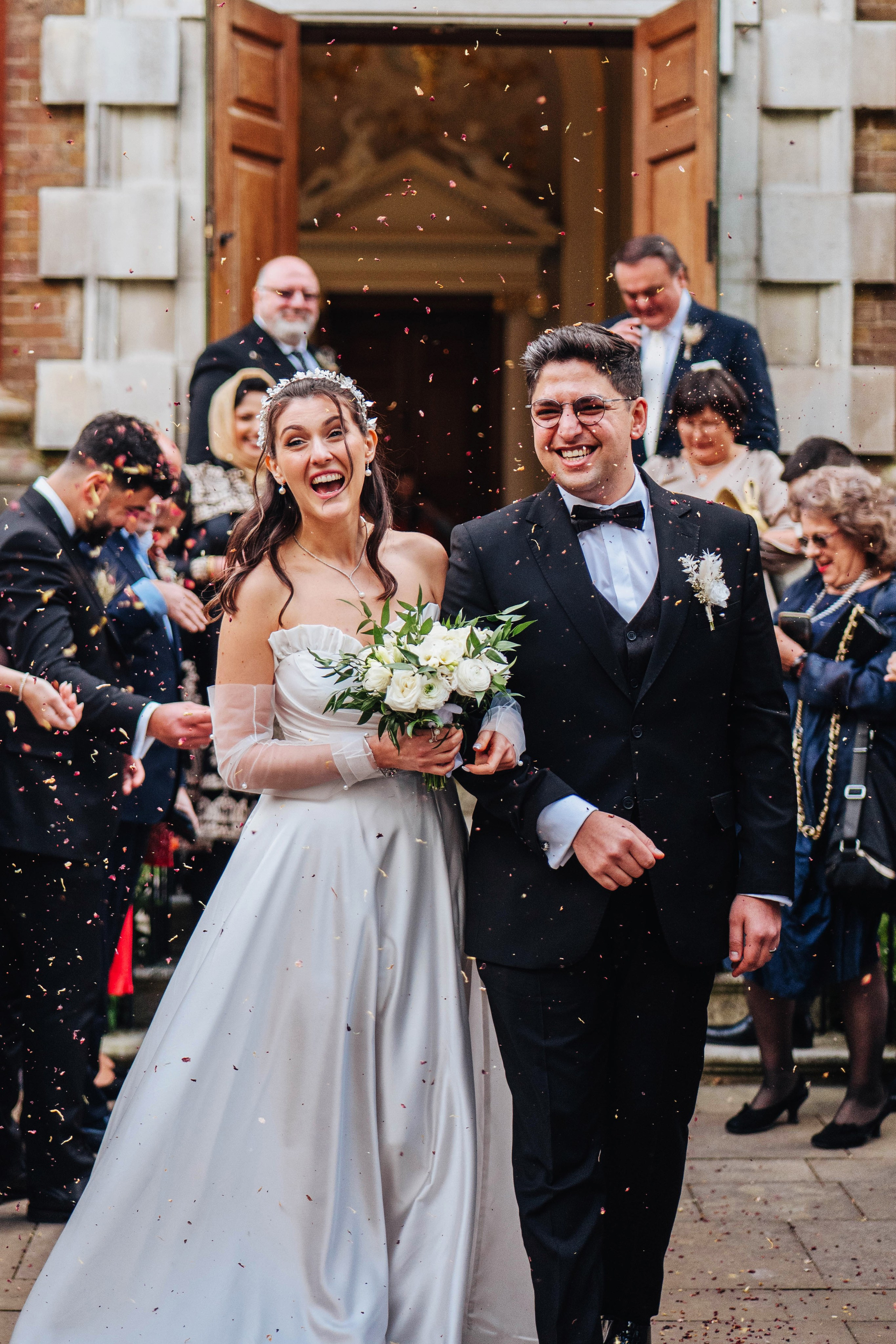 photo of the wedding ceremony, close up of bride and groom laughing after the confetti