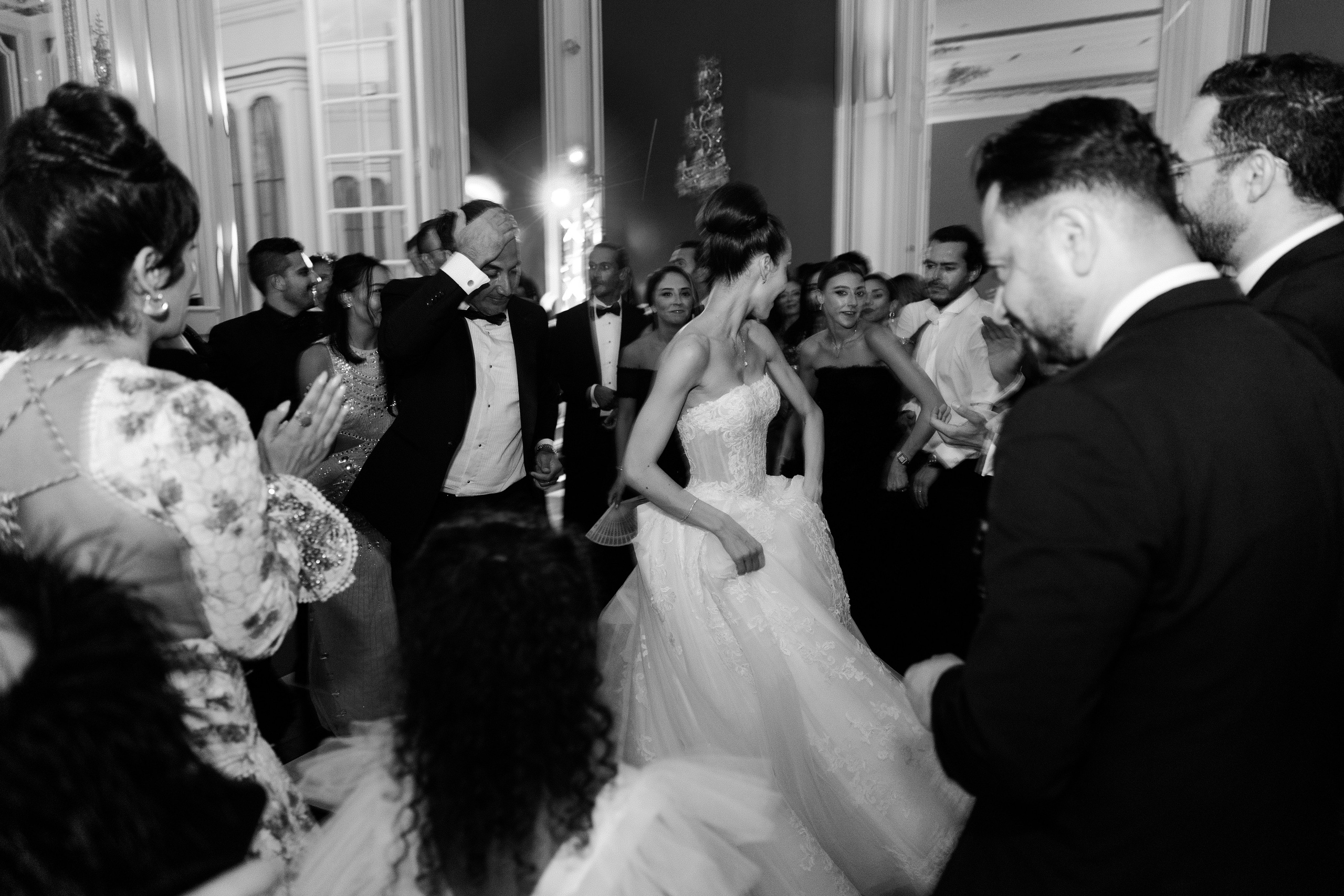 Elegant wedding party in a French château captured in a dynamic black and white documentary style
