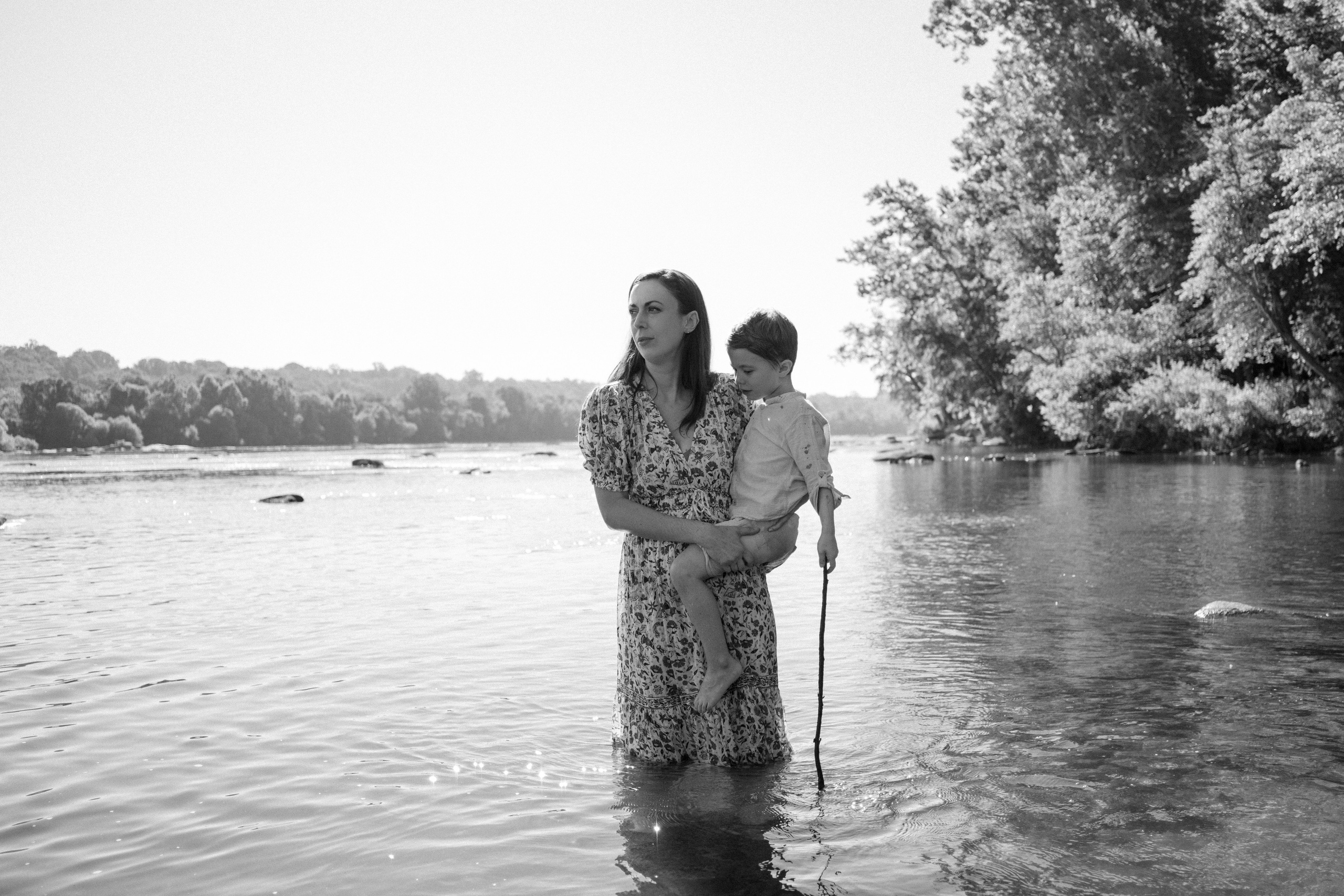 An adventurous family silhouette against the beautiful morning sunlight reflecting off the James River