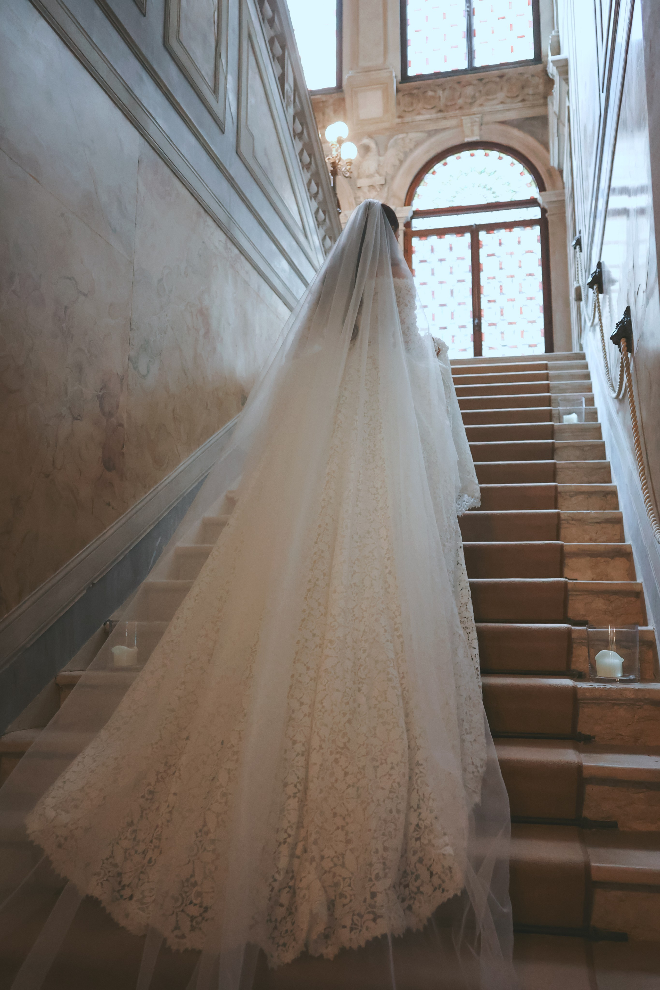 Dramatic photo of Armenian bride with her veil flowing in the courtyard of Aman Venice