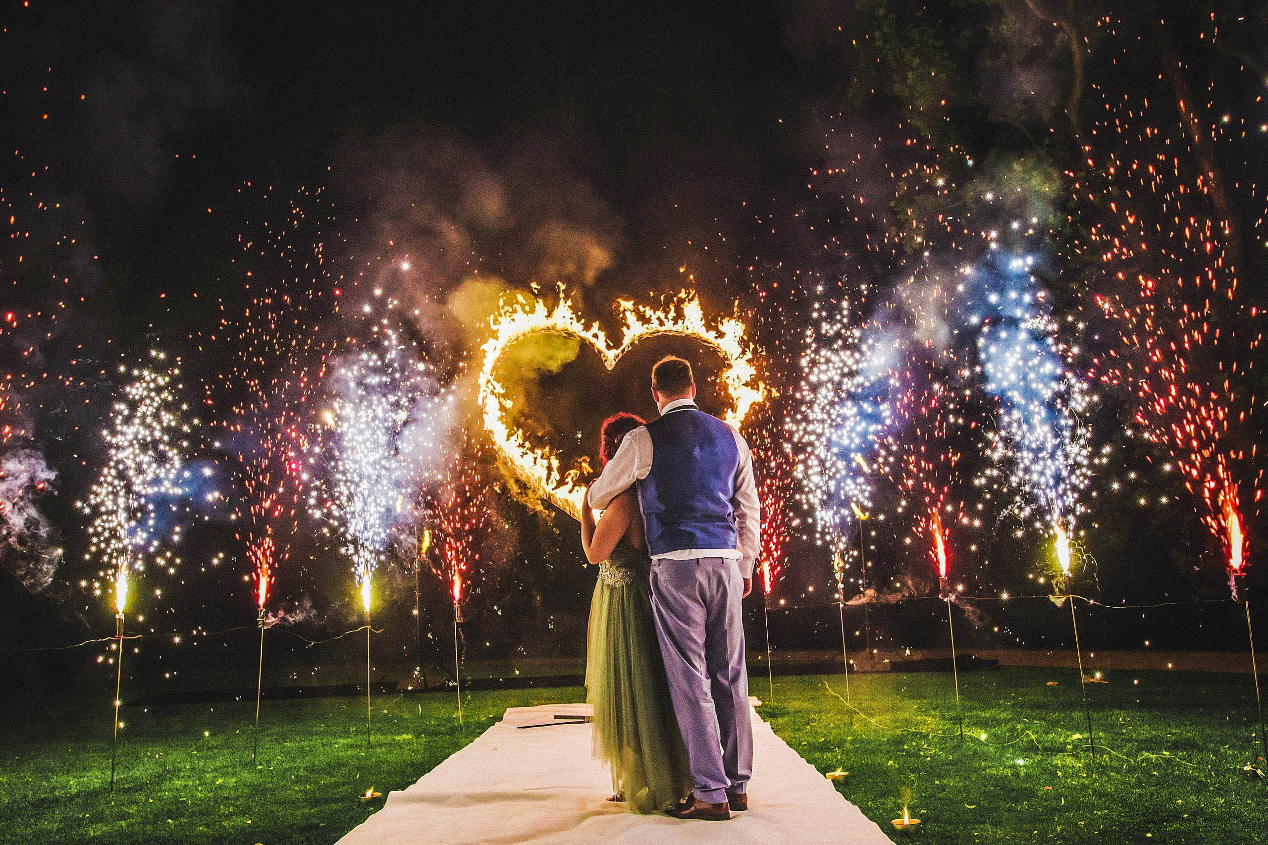 A Dutch bride & groom watch a Fire Show during their wedding day festivities at the Chateau Mcely during their destination wedding.