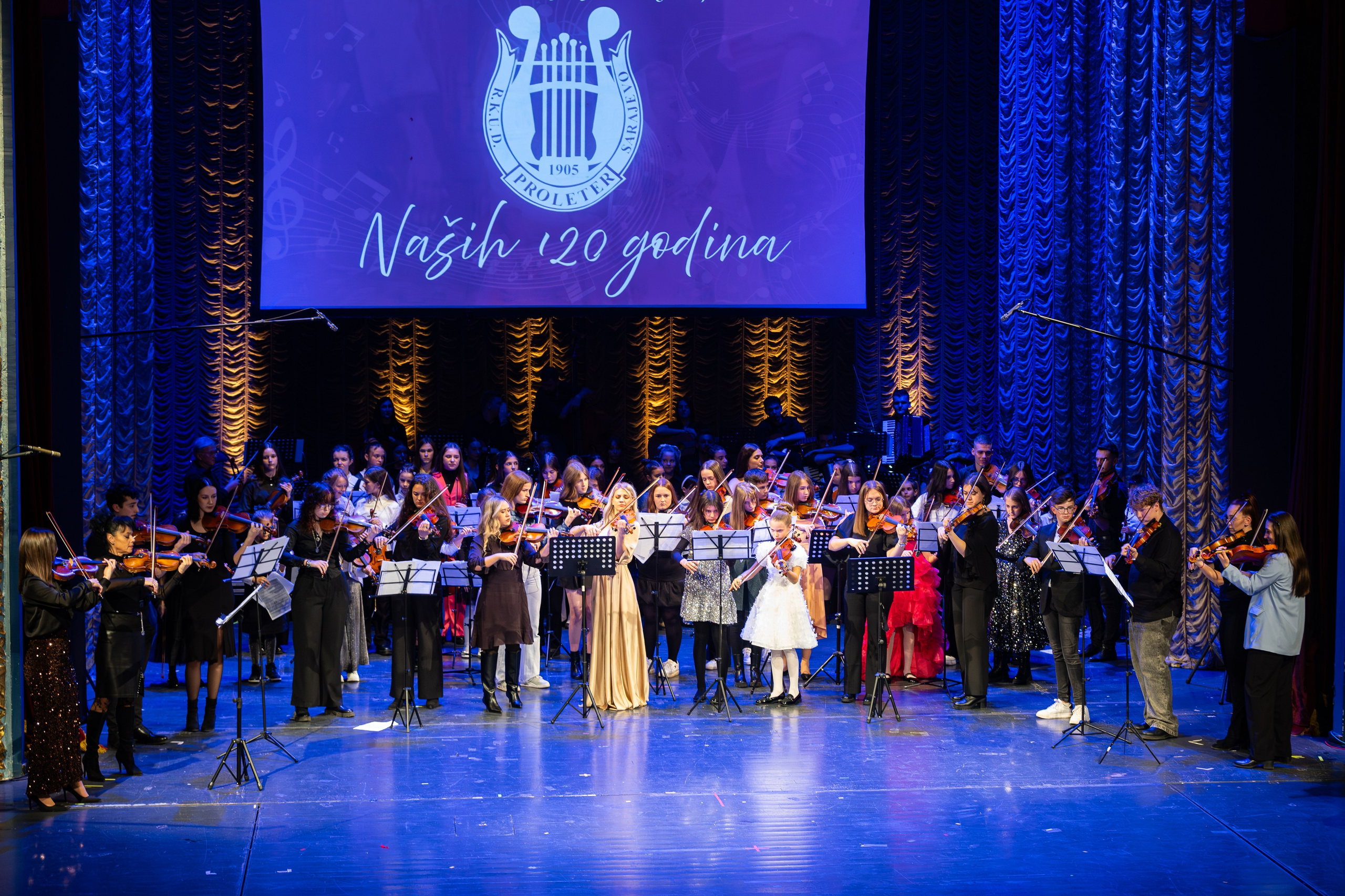 Ceremonial Concert RKUD Proleter is a photography series by photographer Namir Čomaga, documenting a special cultural event celebrating the rich musical and folkloric heritage of Bosnia and Herzegovina. The photographs were created in Sarajevo, capturing moments from the ceremonial concert of RKUD Proleter, including traditional folk dance performances, musicians, orchestral ensembles and the vibrant atmosphere of the stage. Through event and cultural photography, the gallery presents the beauty of traditional costumes, live performances and the cultural identity preserved through music and folklore. This gallery is part of the author’s photography portfolio focusing on Sarajevo photography, event photography, cultural heritage photography and performance photography in Bosnia and Herzegovina.