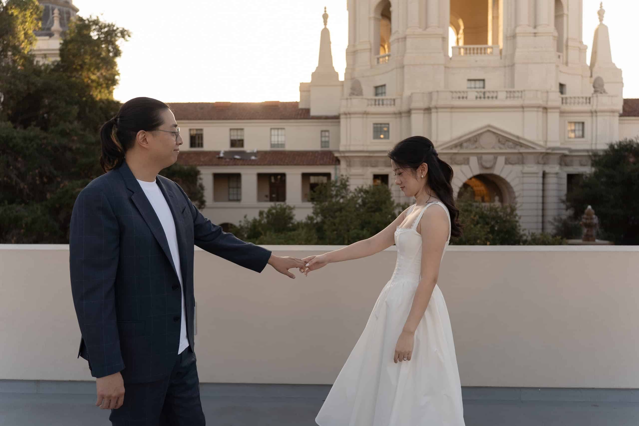 Couple holding hands during sunset portraits at Pasadena City Hall