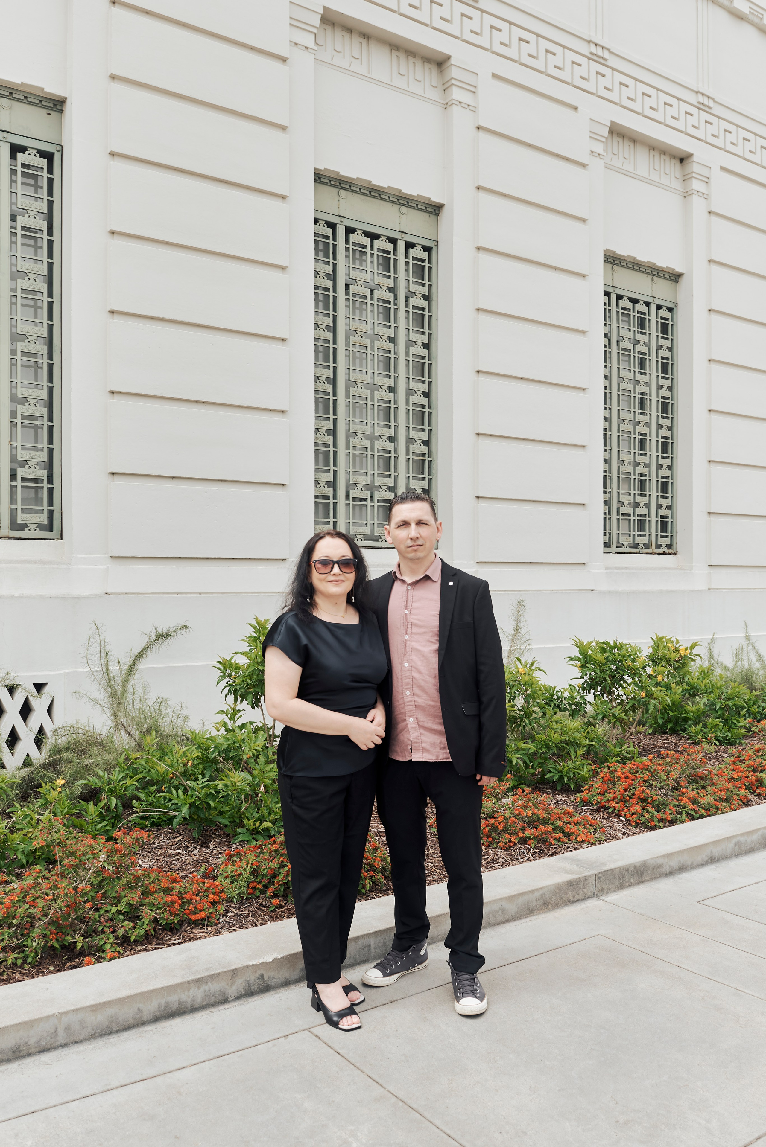 Graduate enjoying a quiet, reflective moment in a beautiful Los Angeles garden