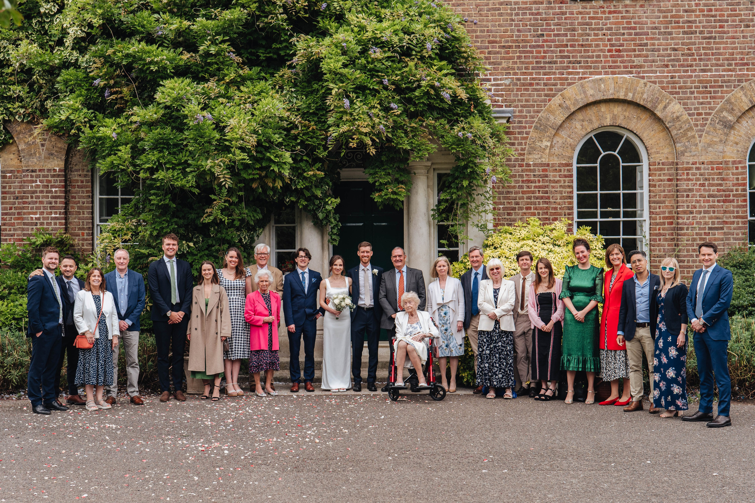 group photo of bride, groom and guests after the wedding ceremony