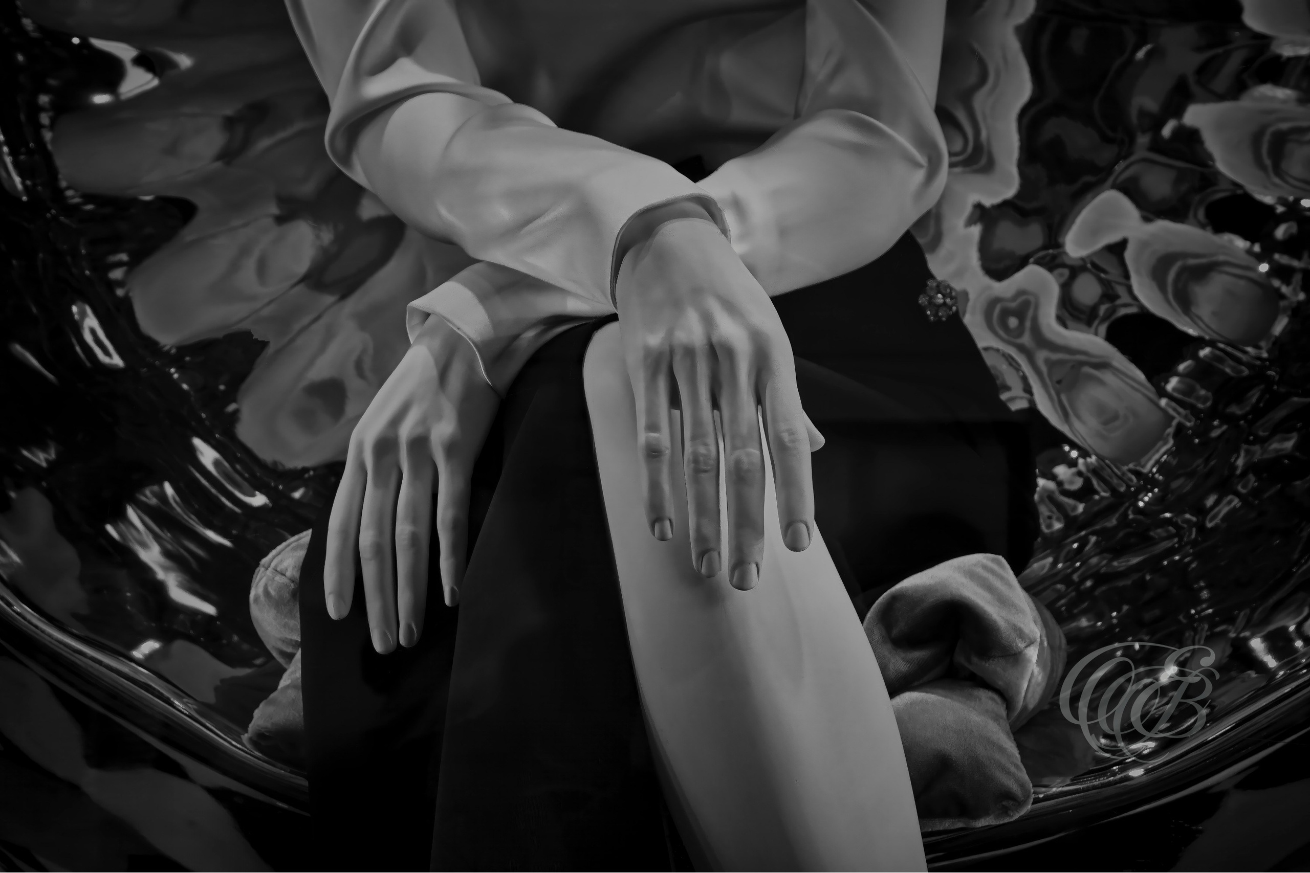 ITALY – FLORENCE — Prada Mannequin Hands Window Display Matte Black and White — Close-up of mannequin hands in elegant crossed pose inside Prada boutique display, showing fashion display design, sculptural gesture, and refined composition, Florence, Italy — Eduardo Bartoli Photography.
