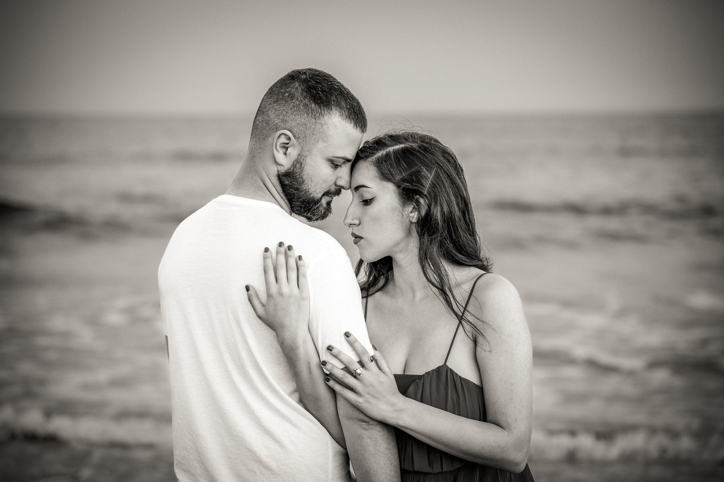 Romantic Getaway: Maspalomas Photo Session A black and white photo of a couple embracing on the beach.