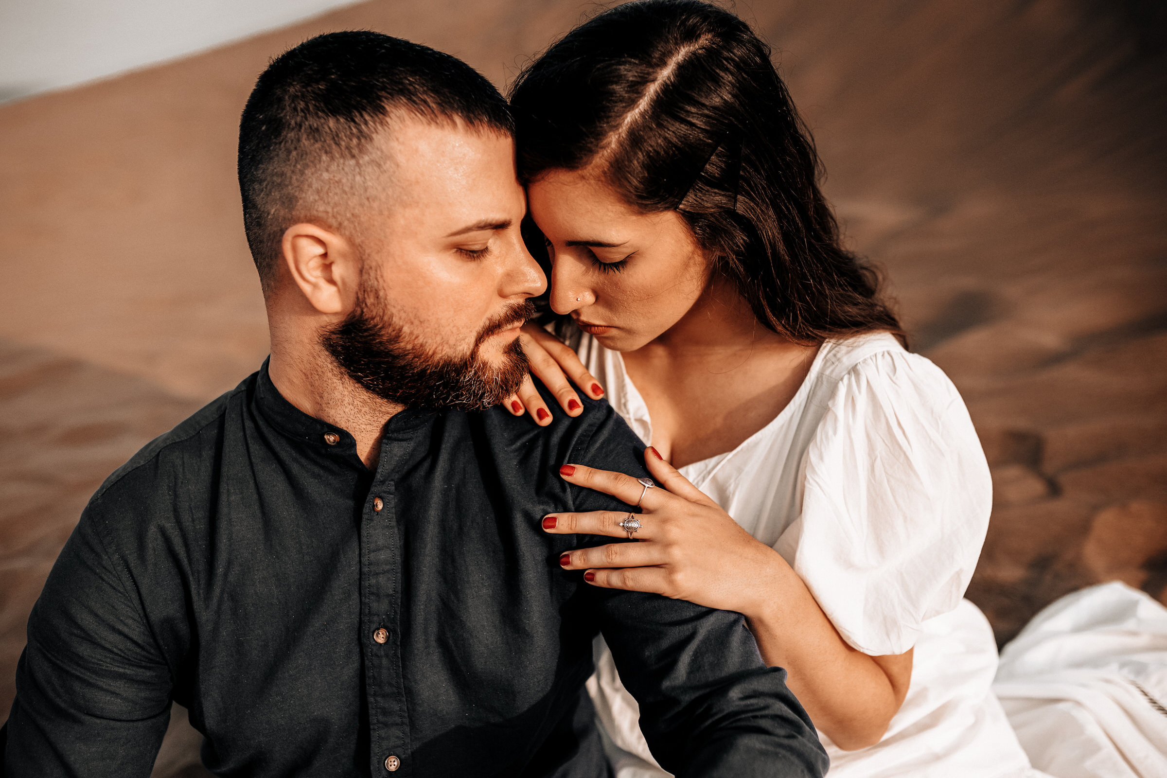 Gran Canaria Love Story: Skilled Photographer's Art A man and woman are embracing in the desert of  Dunas Maspalomas