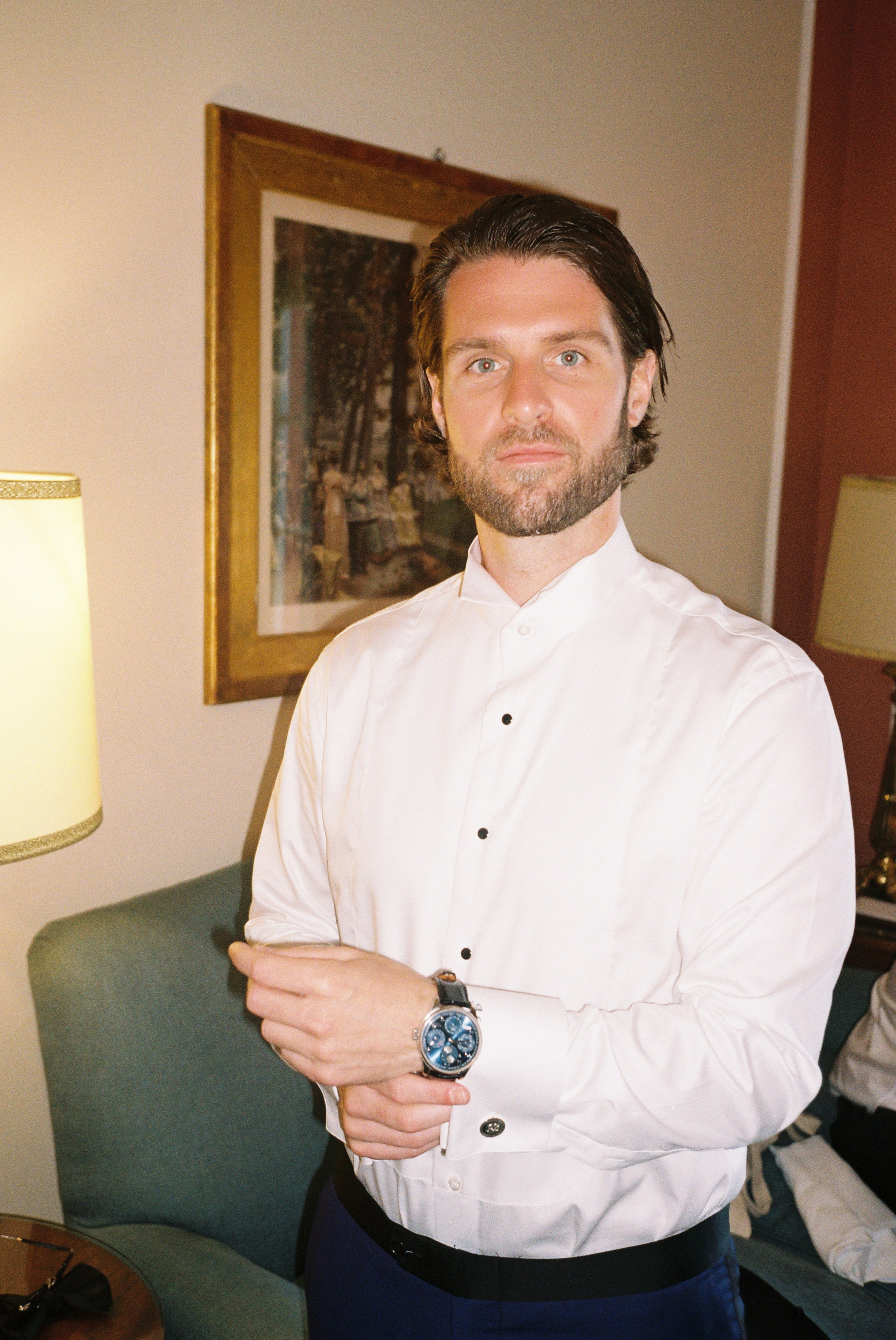 Refined groom perfects his look, showcasing timeless style and sophistication.