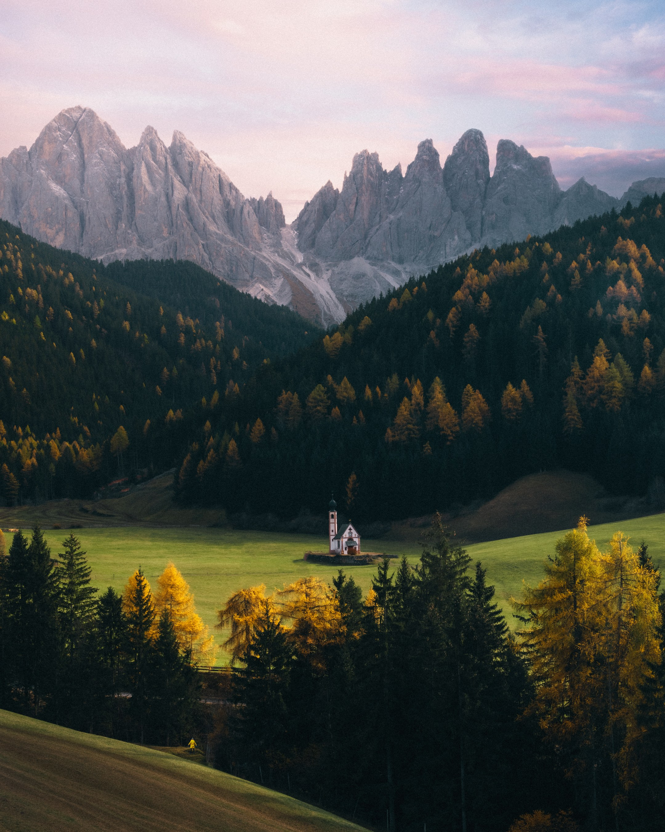 A photo of a church in the Dolomites Italy during sunset 