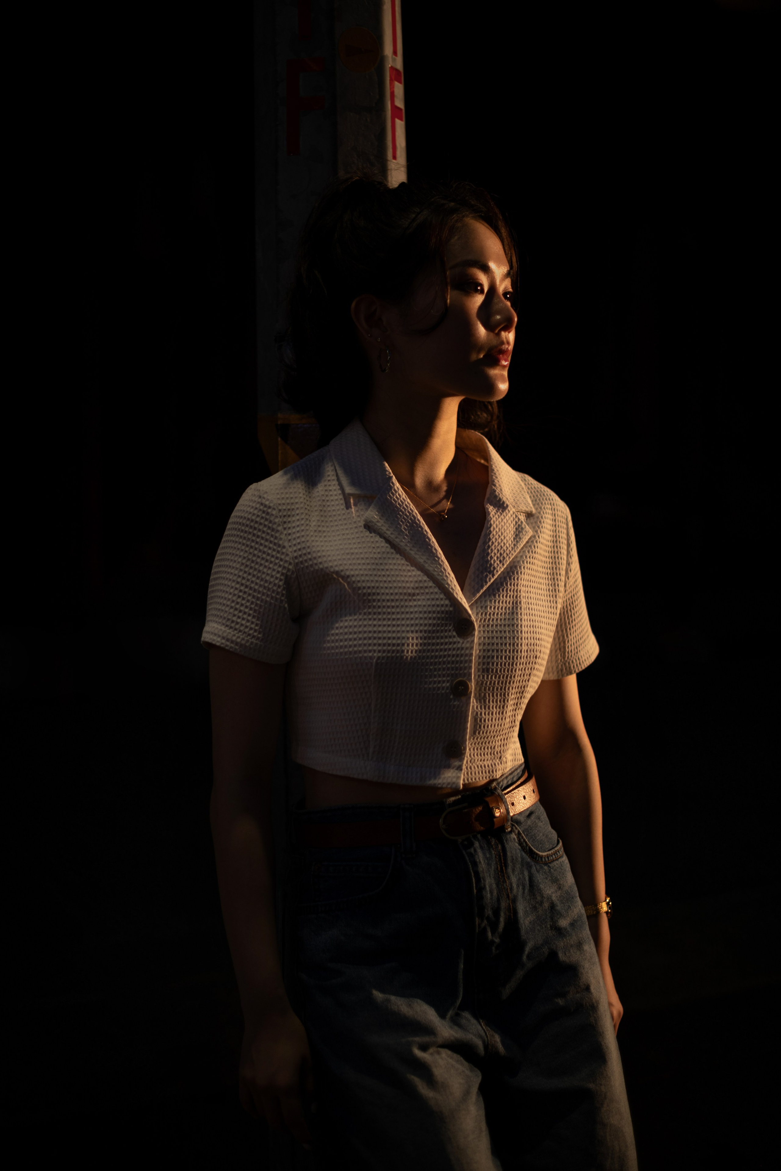 Dynamic nighttime urban scene in Singapore featuring a solitary street light against a vibrant city backdrop. This creative editorial shot by a freelance photographer emphasizes innovative lighting techniques and contemporary urban storytelling.