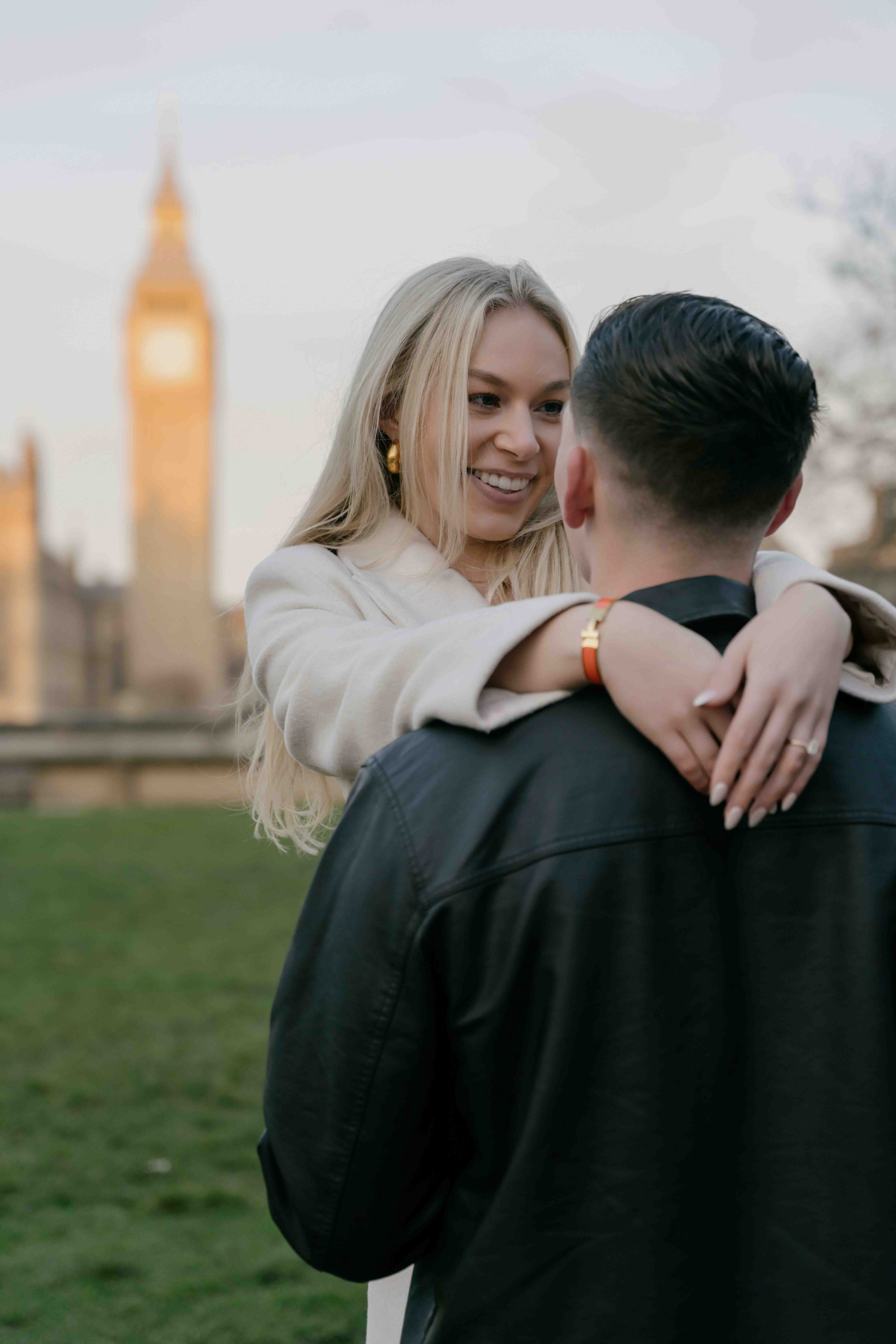 Couple hugging near Big Ben in Westminster London after proposal sunrise