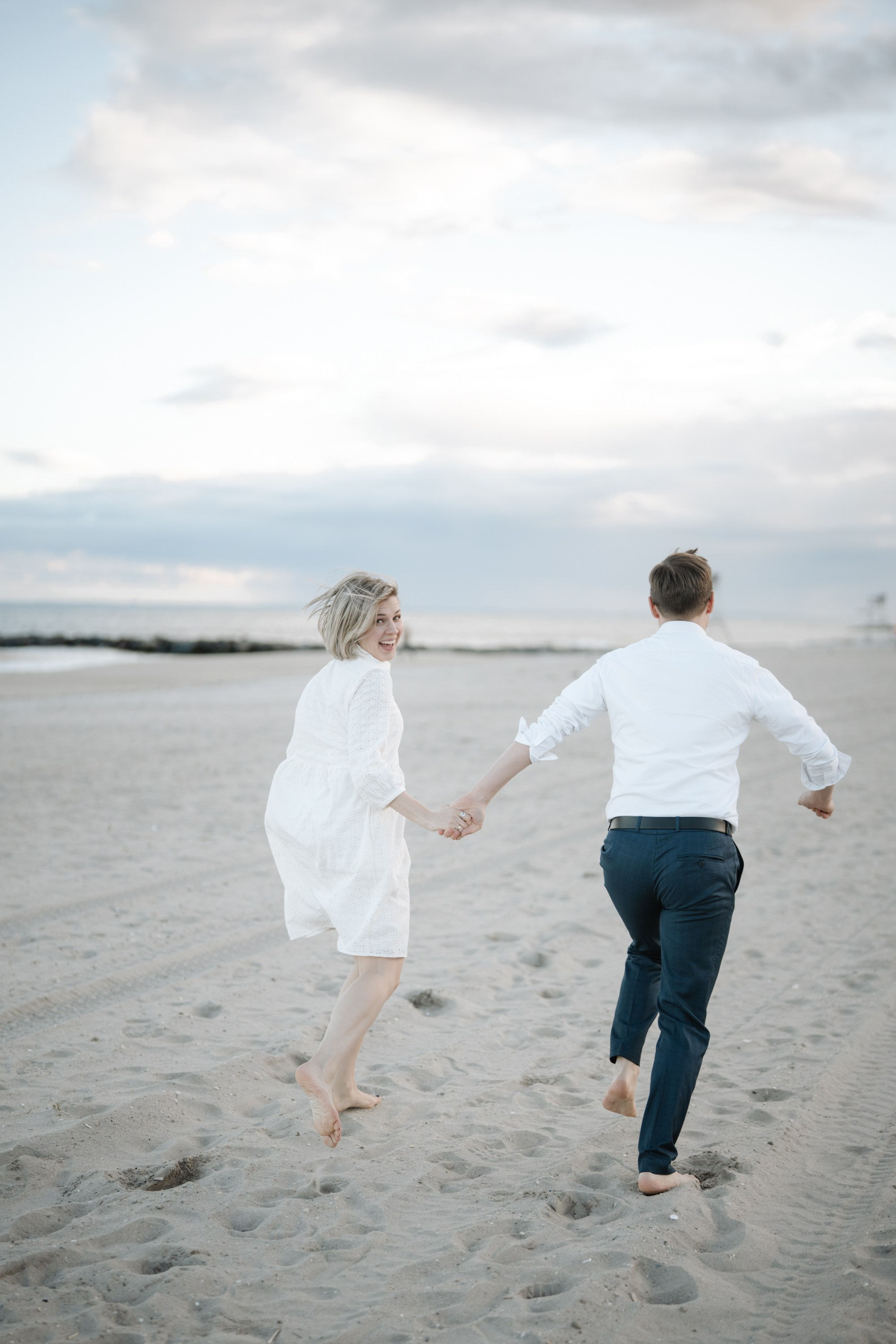 Candid photos of a couple on the beach. Portrait and wedding photographer in New York
