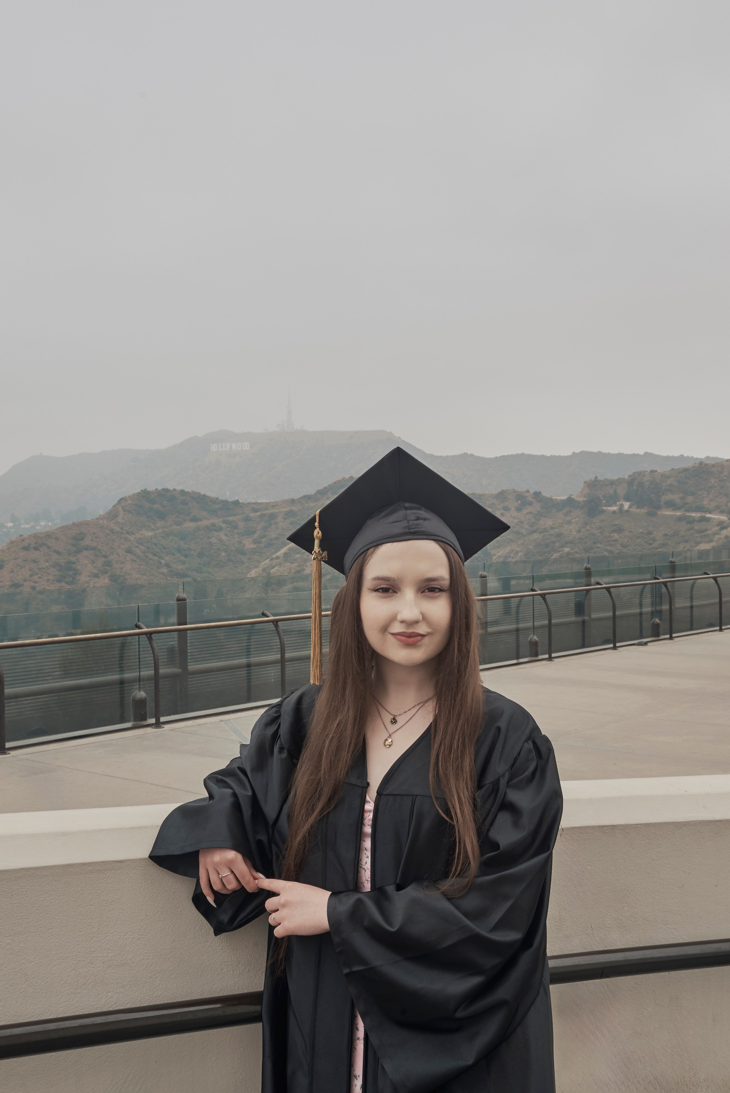 Elegant graduation photo of a student standing near the Los Angeles County Museum of Art