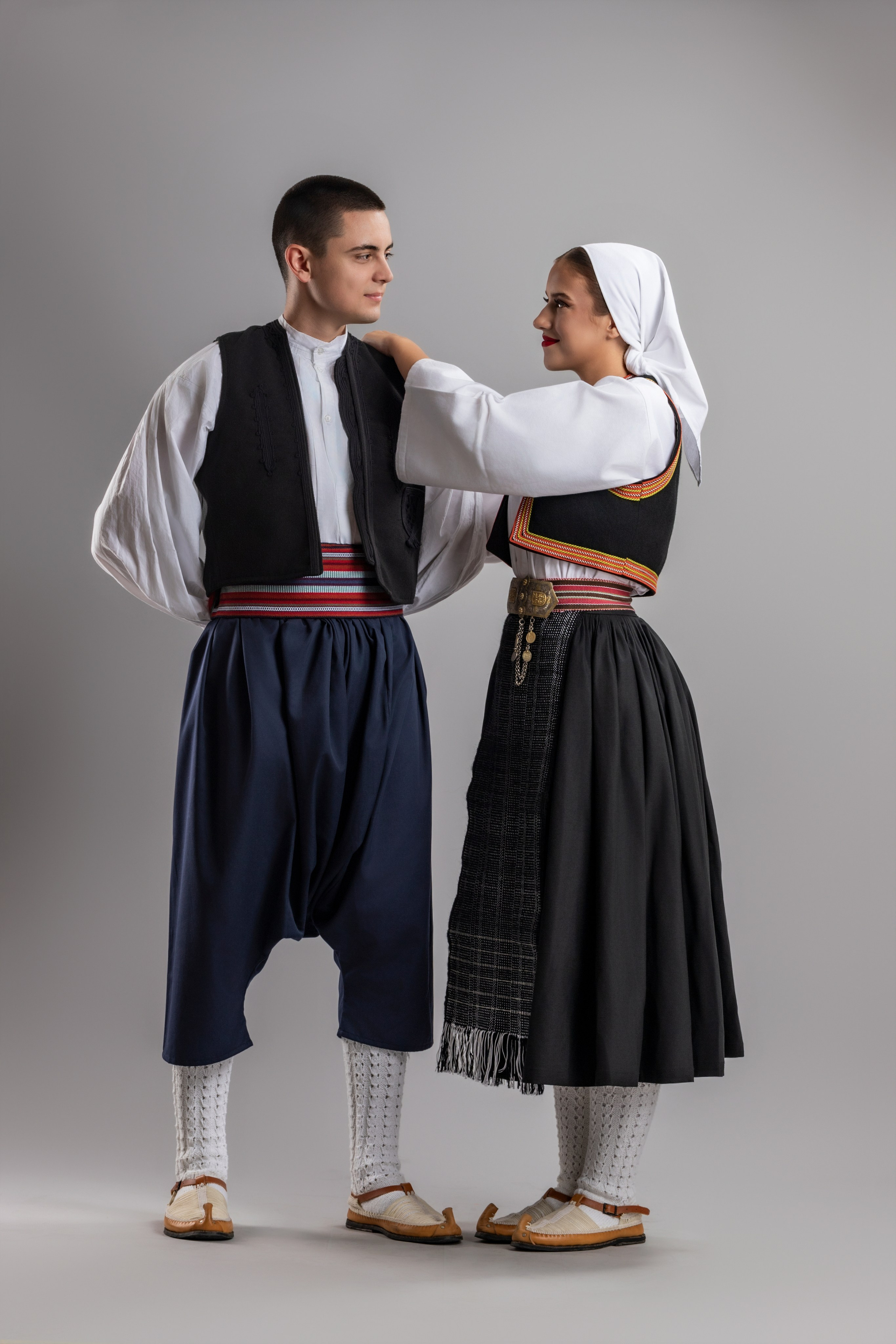 Studio portrait photography of traditional folk costumes from Bosnia and Herzegovina featuring authentic cultural clothing, embroidery, jewelry and handcrafted garments, photographed by Namir Čomaga. The images highlight the richness, craftsmanship and cultural heritage of Bosnian traditional costumes through carefully lit studio portraits.