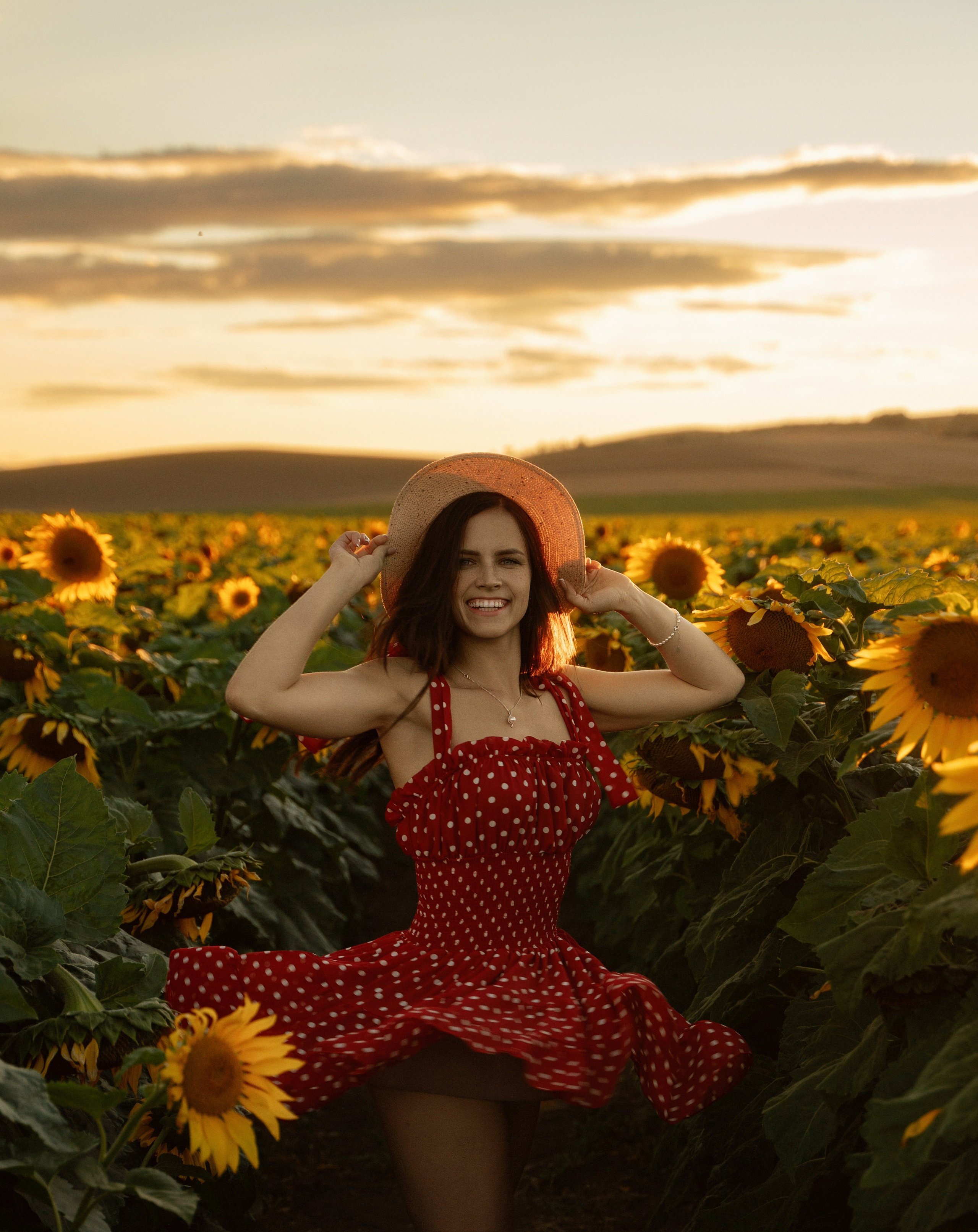 Portrait of young female model in sunset sunflower field by Marbella-based photographer