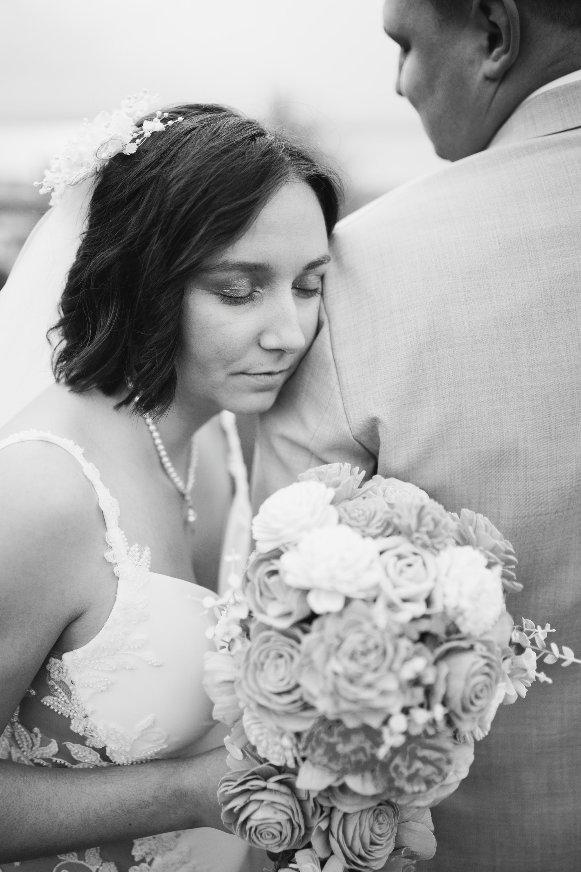 Bride holding bouquet, black and white candid moment