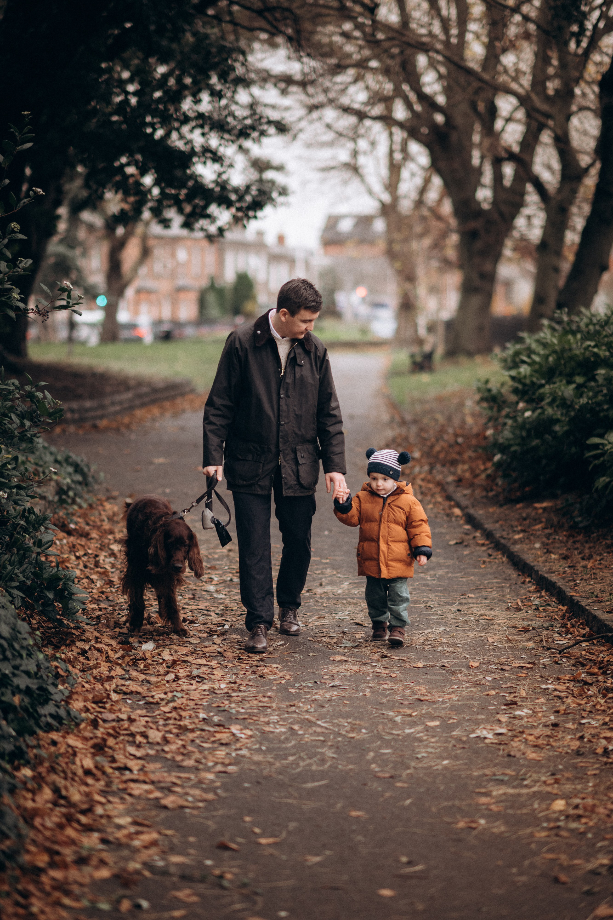 father with child and dog in the park