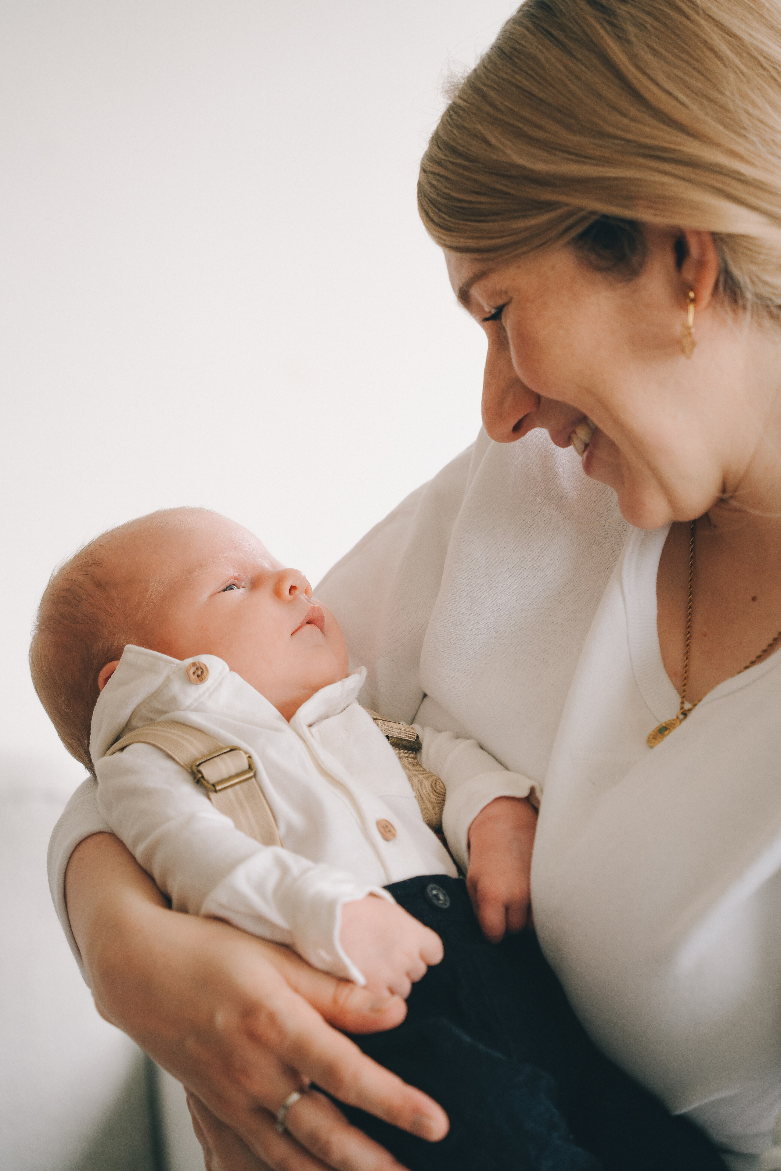 Cuddling newborn baby during at-home photo session in Solihull, full of warmth and love.