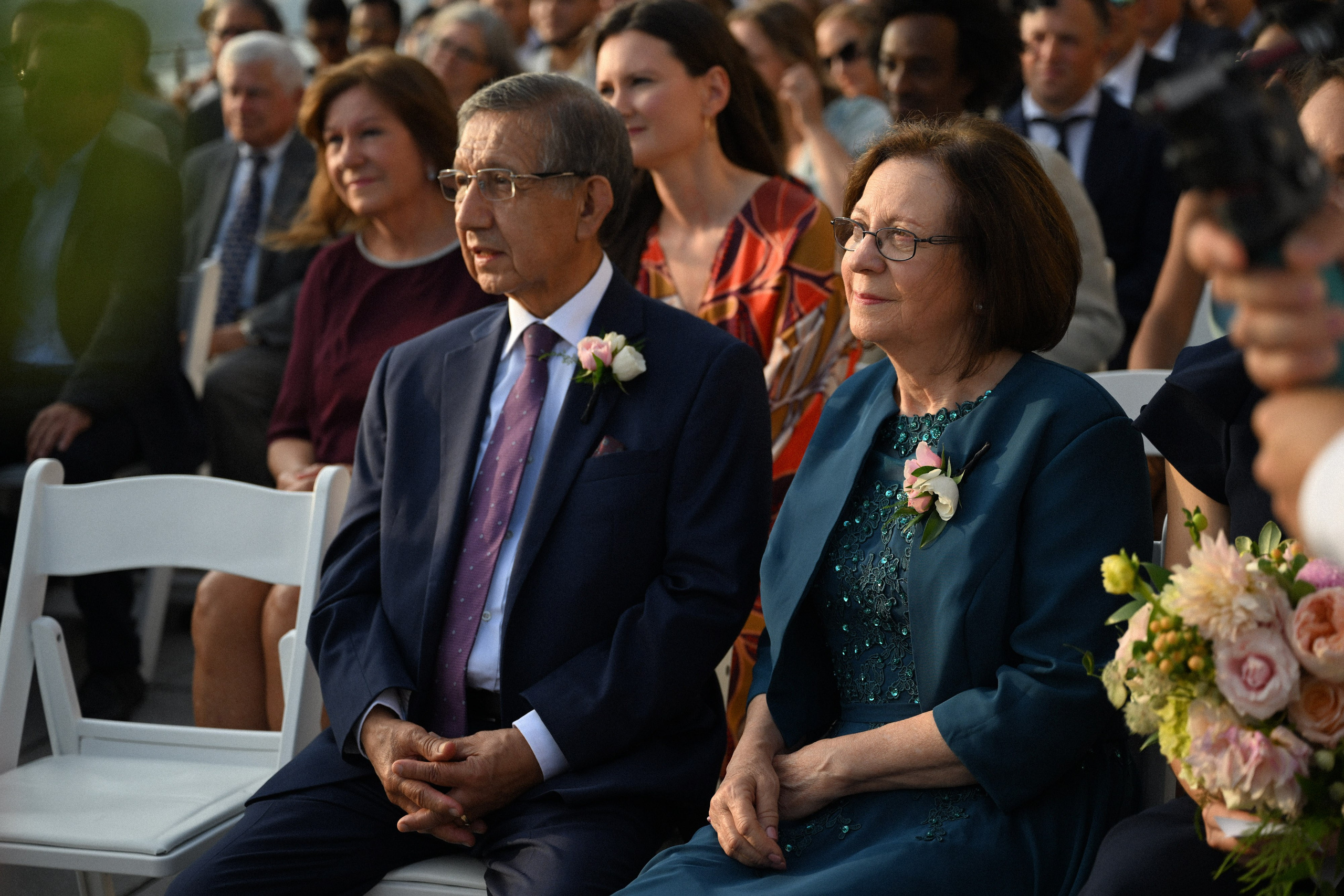 a man and woman sitting in a crowd