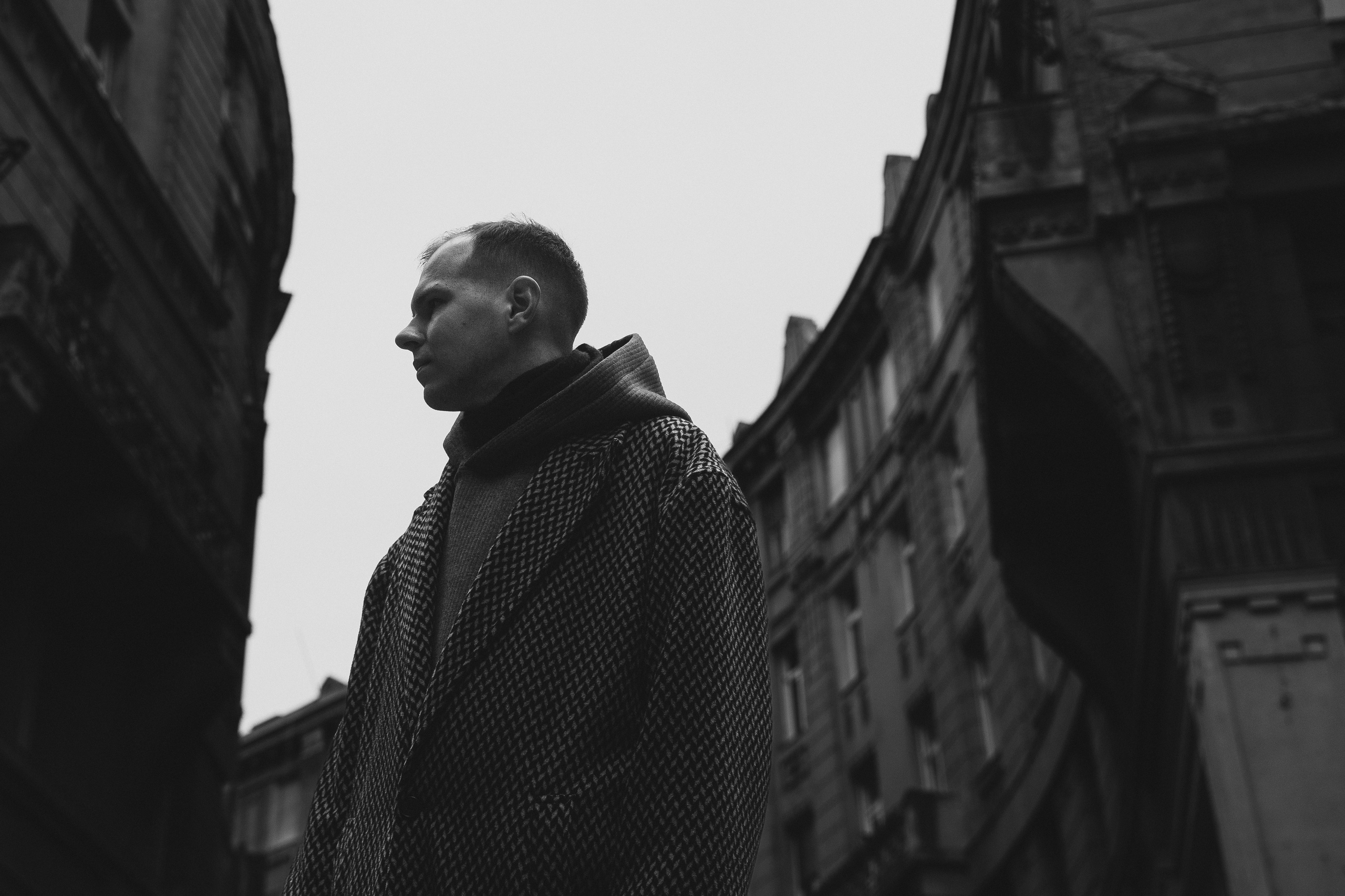 profile portrait of a man between buildings in Budapest