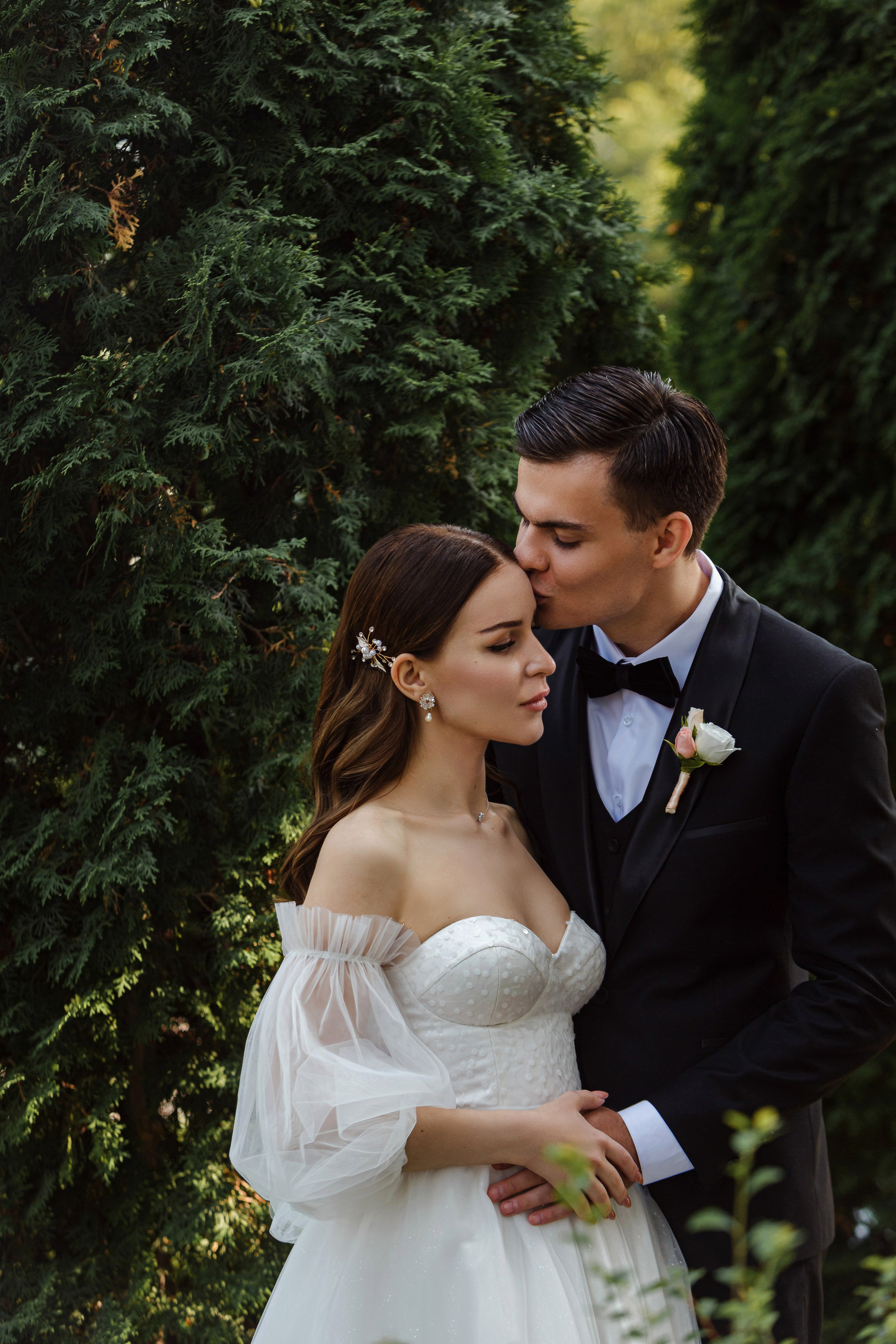 El novio besa a la novia en el Jardín Botánico del Cullera