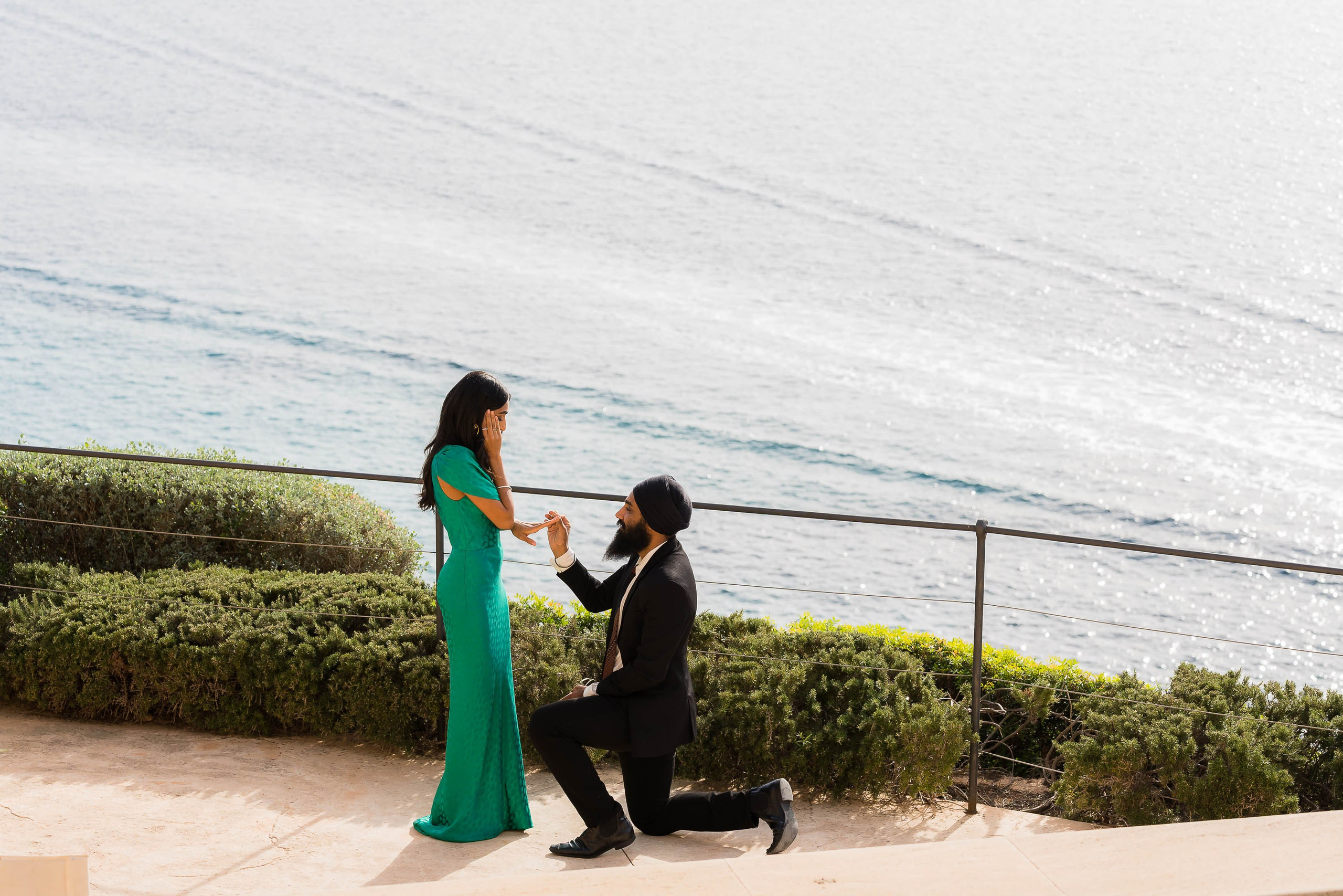 American couple proposes with Mediterranean sea behind at Cap Rocat Hotel Venue